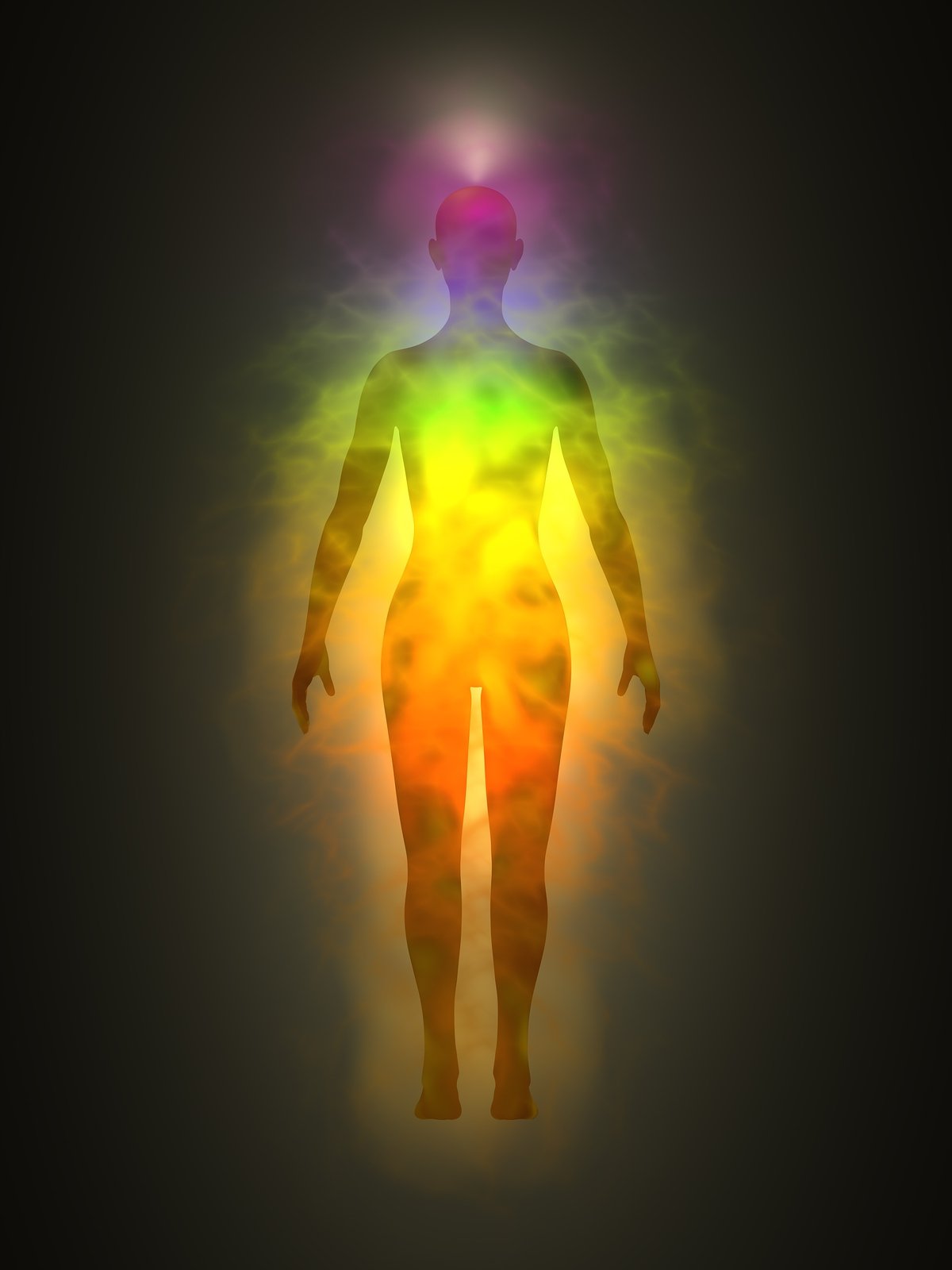 Silhouette of a human figure with colorful light effects highlighting the body's energy centers.