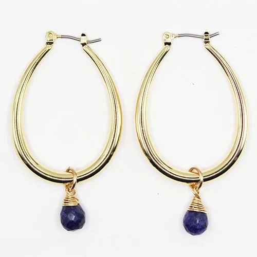 A pair of gold hoop earrings with dark blue teardrop-shaped gemstones hanging at the bottom.