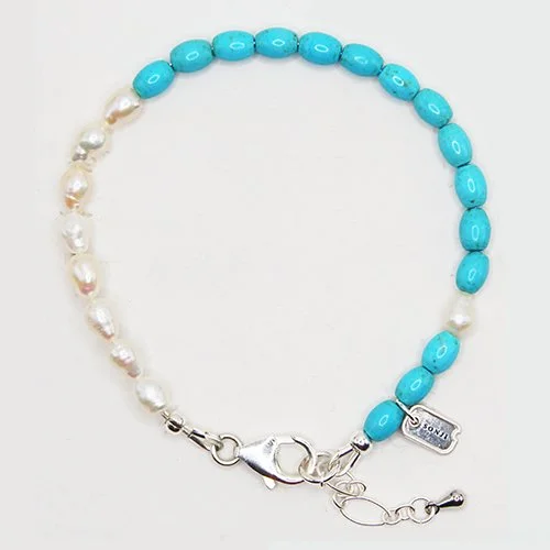 A necklace with a string of turquoise beads on one side and white pearls on the other, with a silver clasp and a small silver tag.