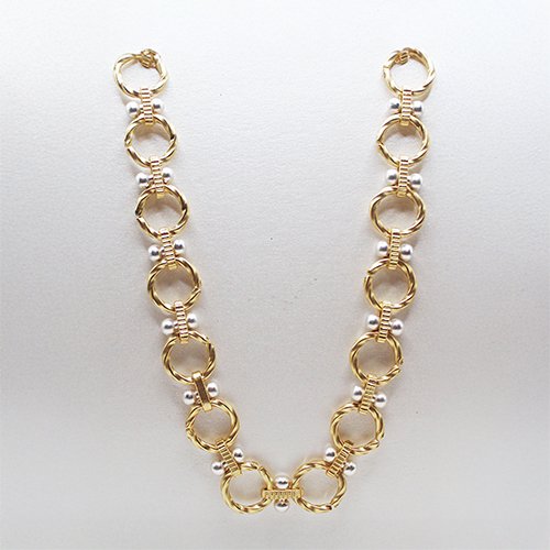 Gold and pearl necklace with interconnected circular links and pearls.