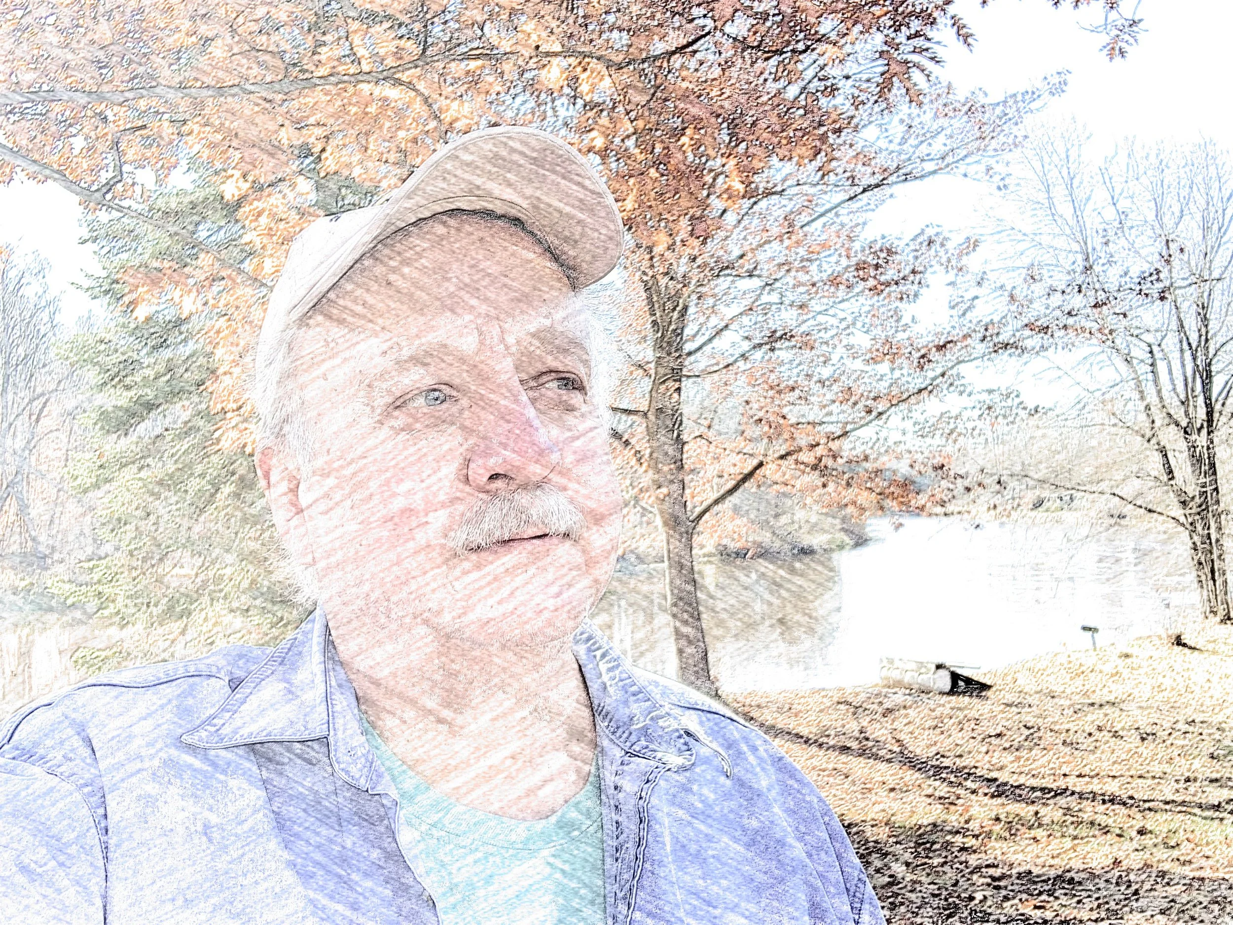 The Author, outdoors among the trees and river that act as inspiration his writing.