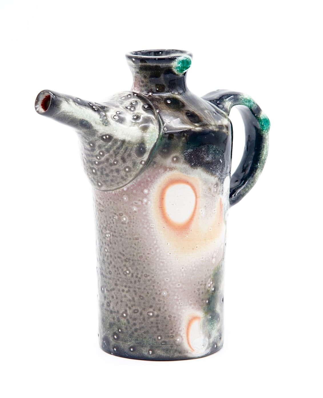 Super pleased with this soda fired ewer. I fired it on its side and you can see the path the soda took over the body during the firing process, and where the soda built up on the handle and lip of the top.
- B clay with coarse silica sand for the pit