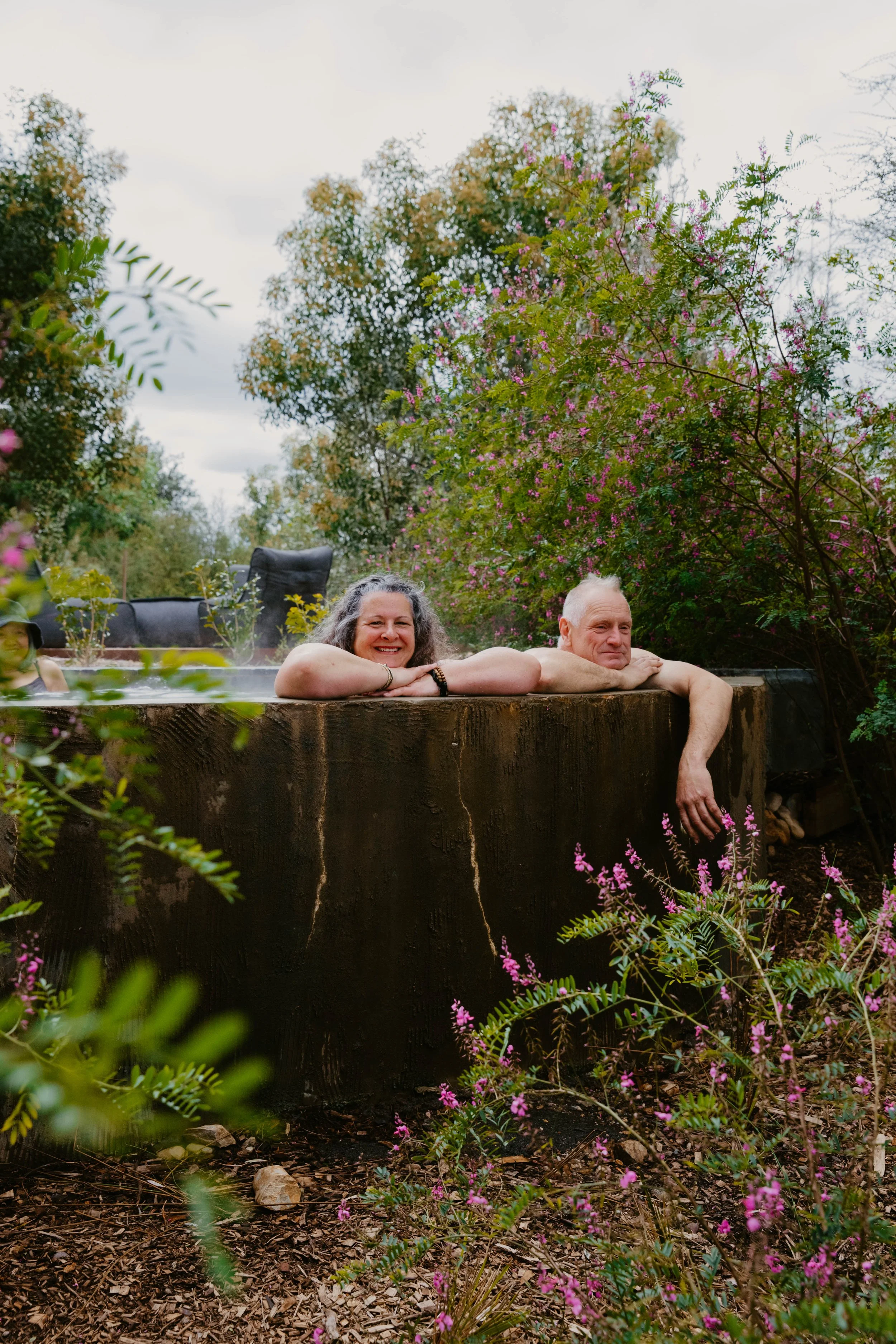 An older couple bathing in hot springs