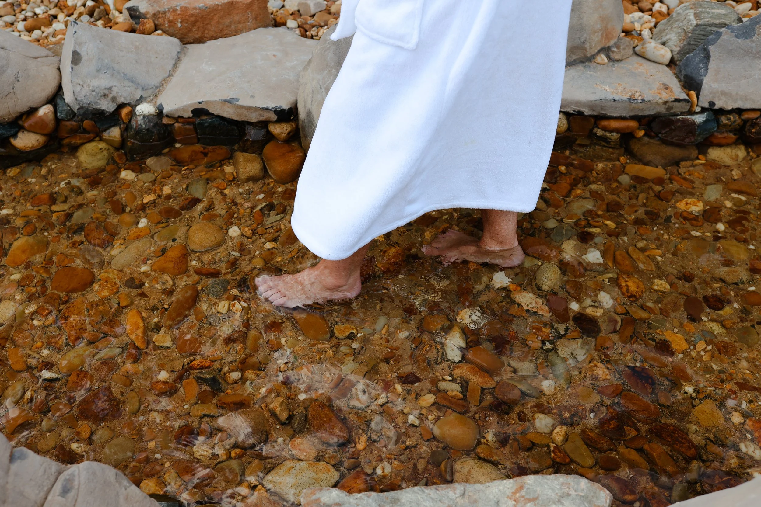 A woman in a robe walking the reflexology walk