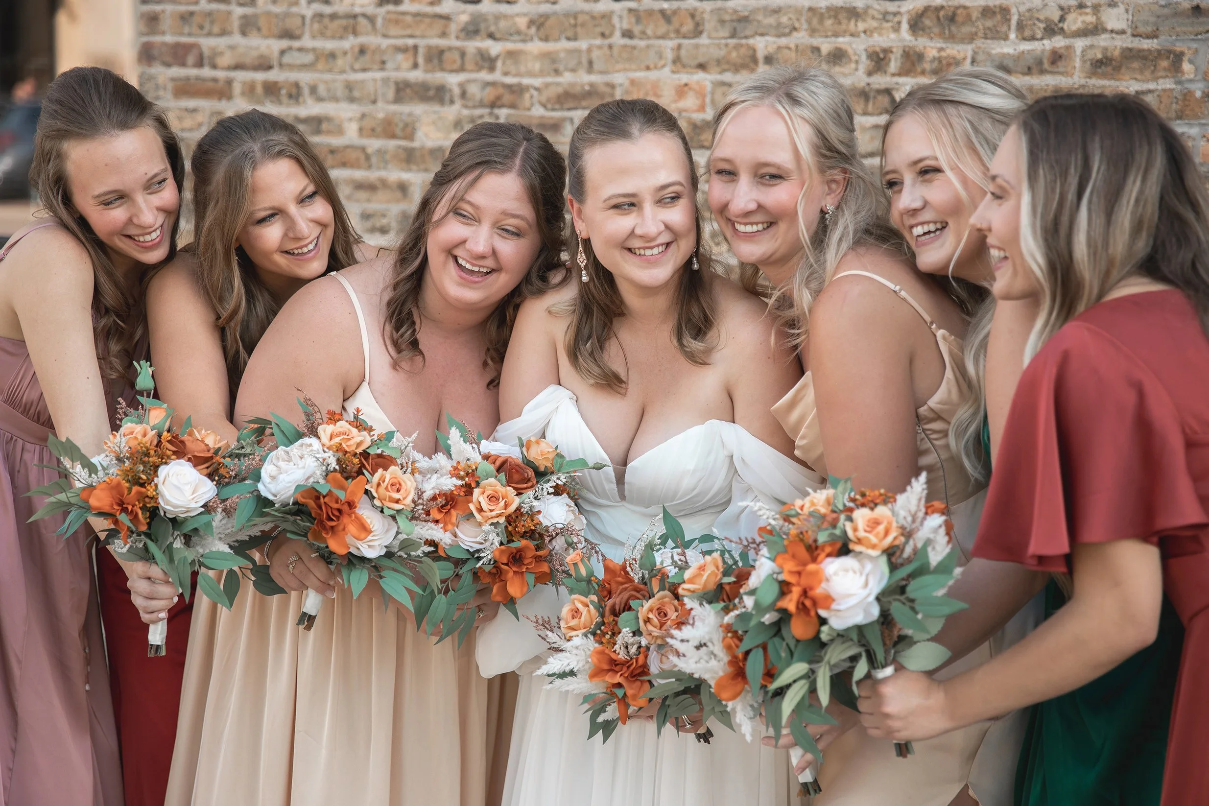 Bride laughing with her bridesmaids