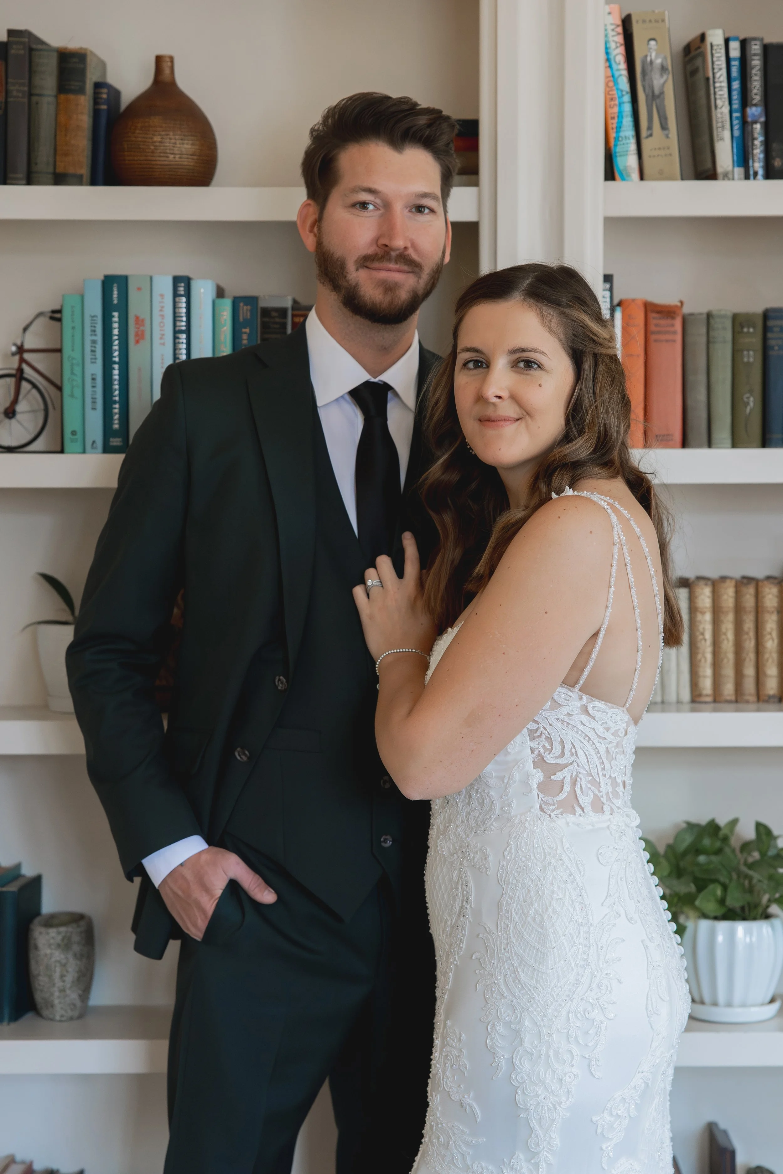 Bride and groom posing in antique library
