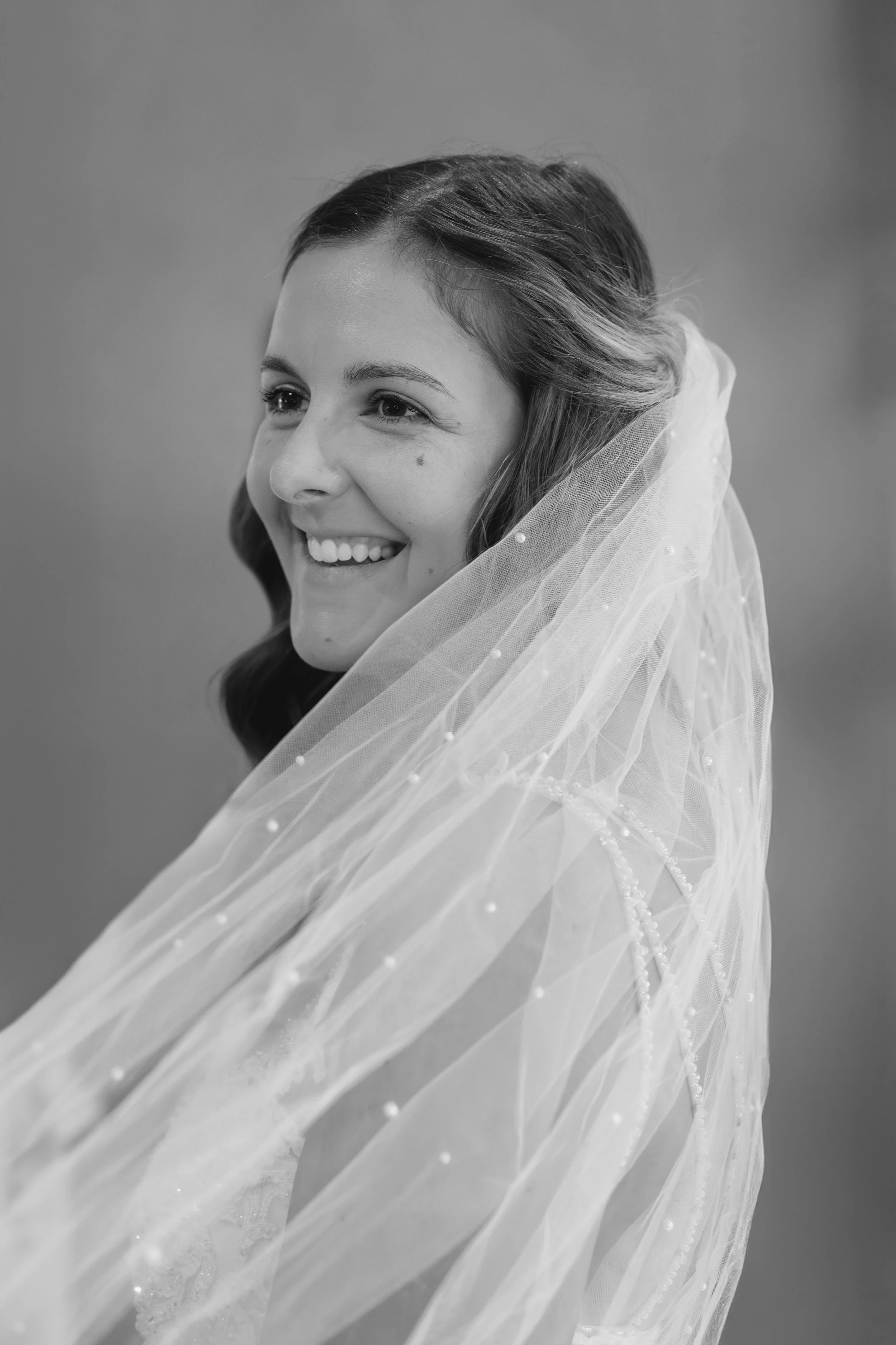 Bride wrapped in veil
