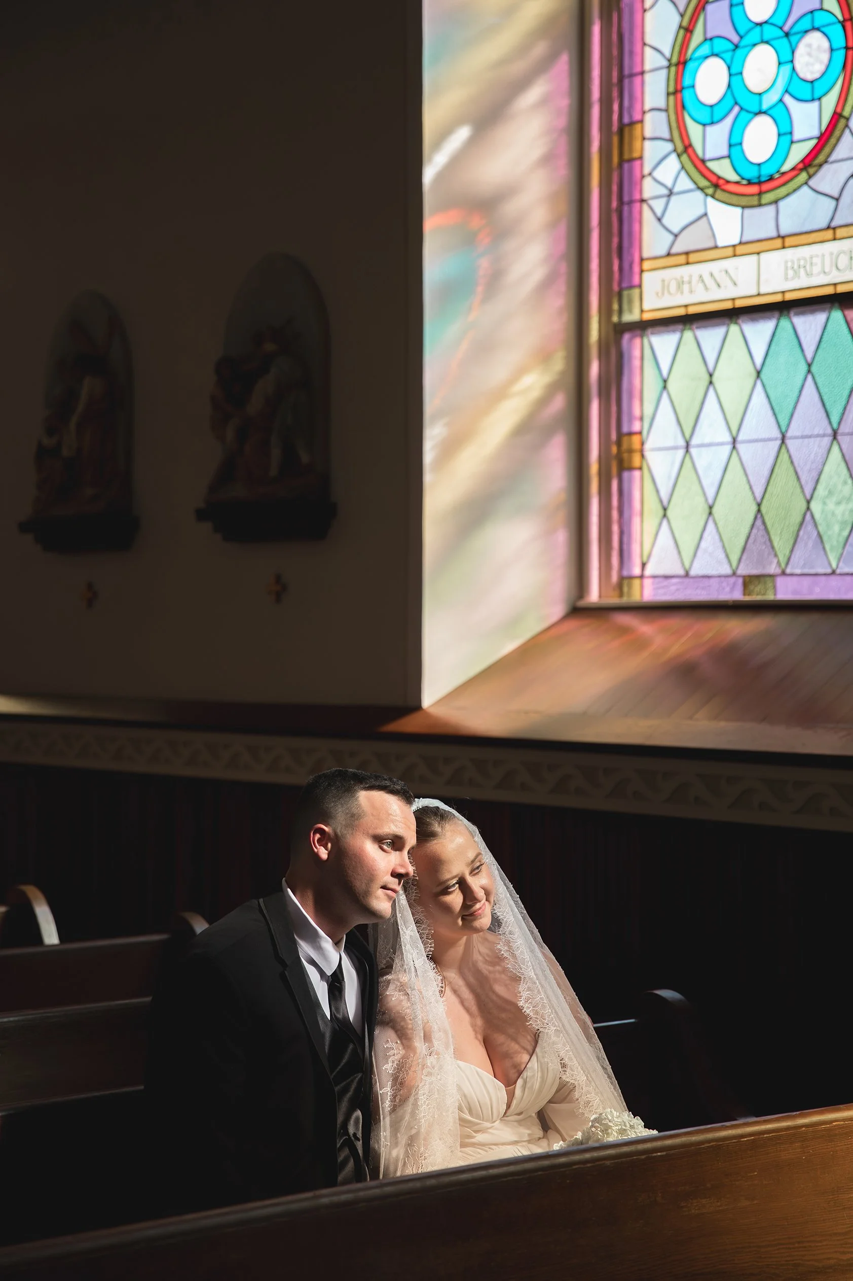 Wedding portrait in front of stained glass