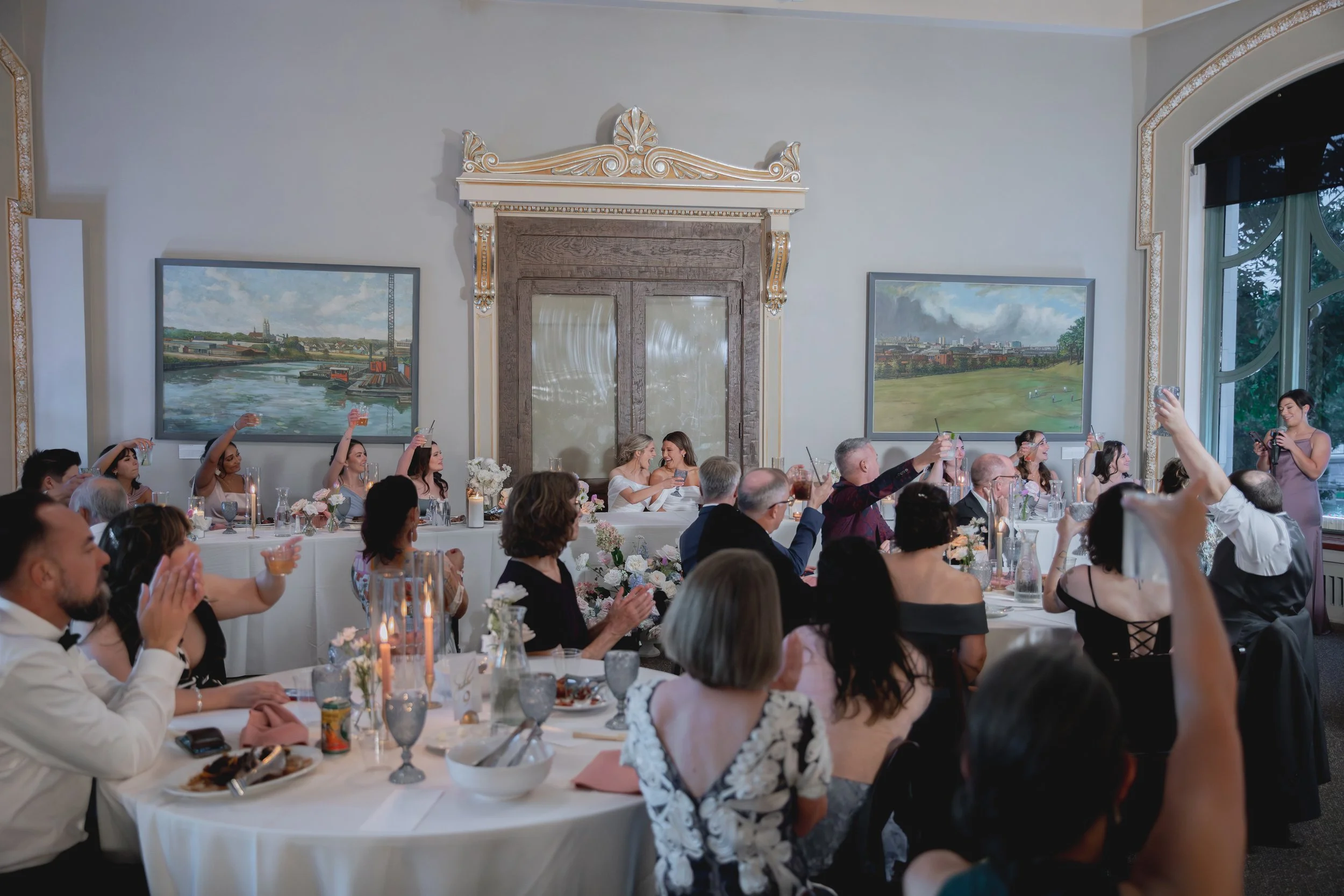 Wedding party toasting to the brides