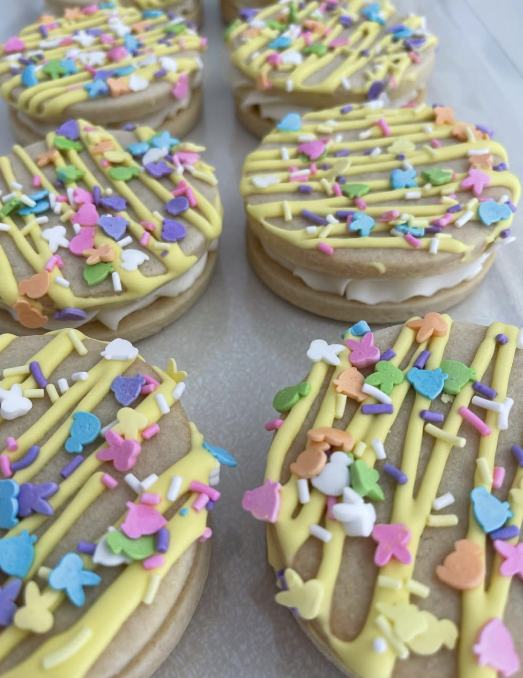 Cookies with yellow icing and colorful sprinkles