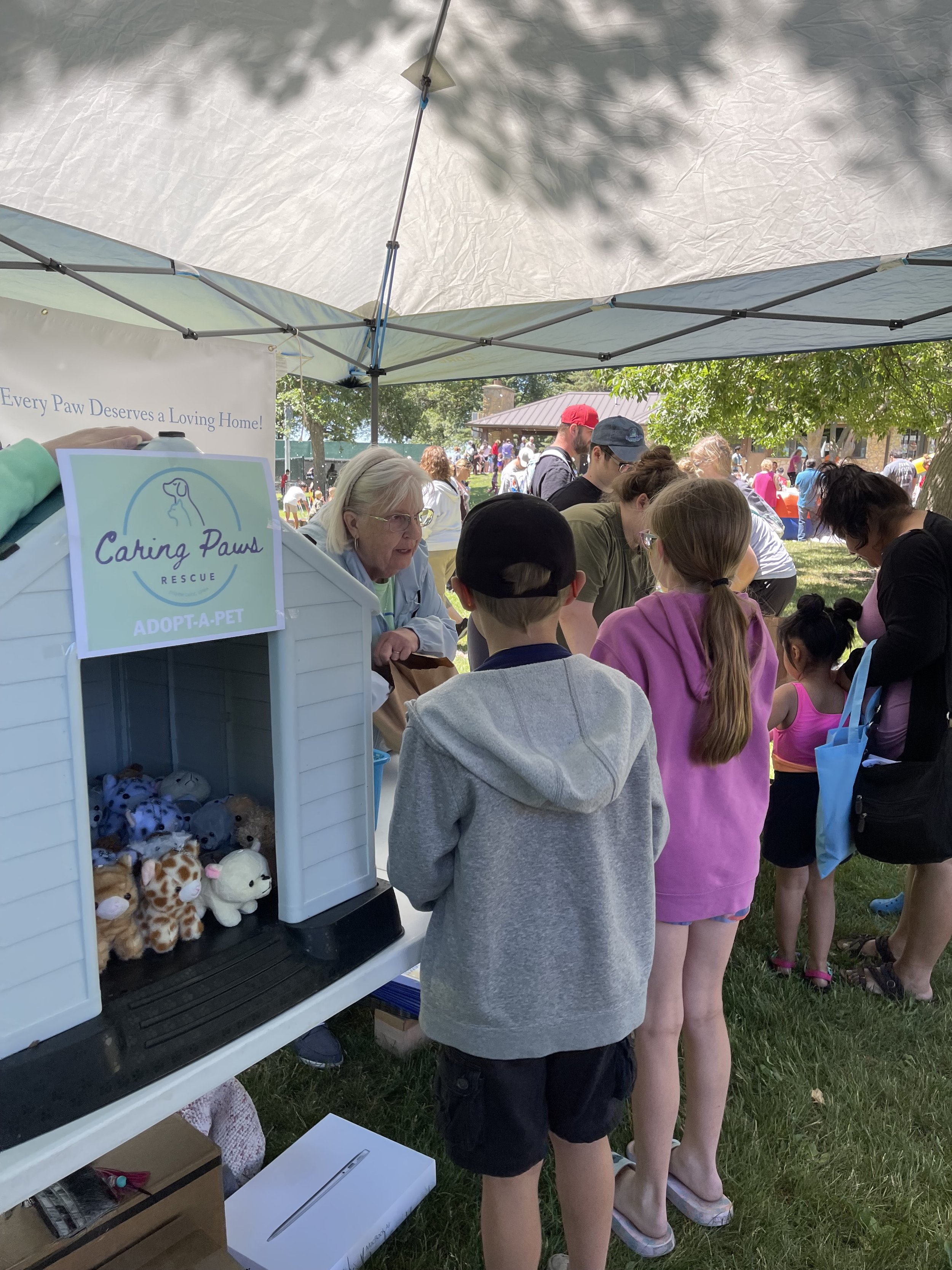 CPR member Deb Langner teaching kids how to care for the "pet" they adopted at KidsFest!