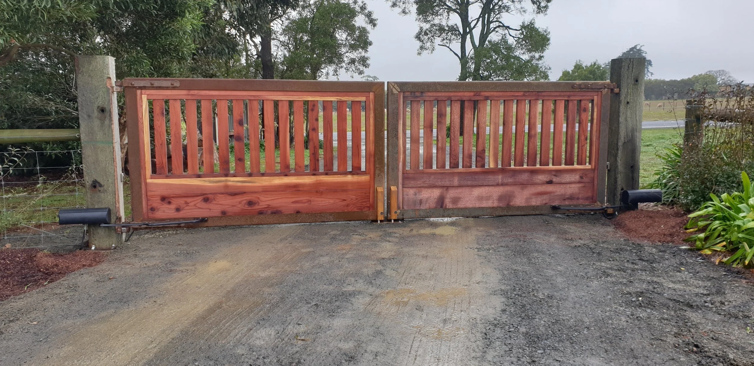 Automated gate — New timber automated double swing gate on property driveway