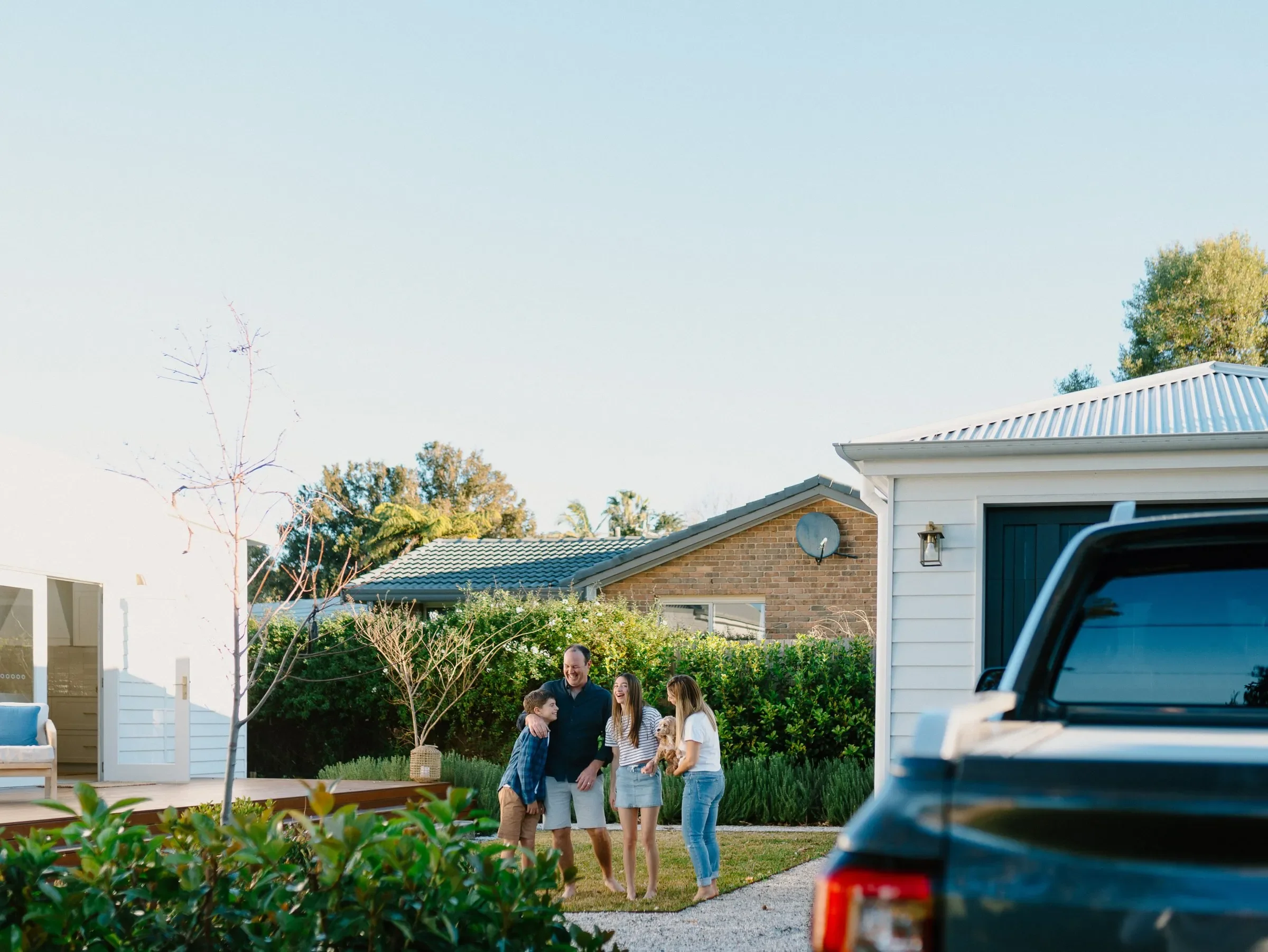Family happy together infront of nice home
