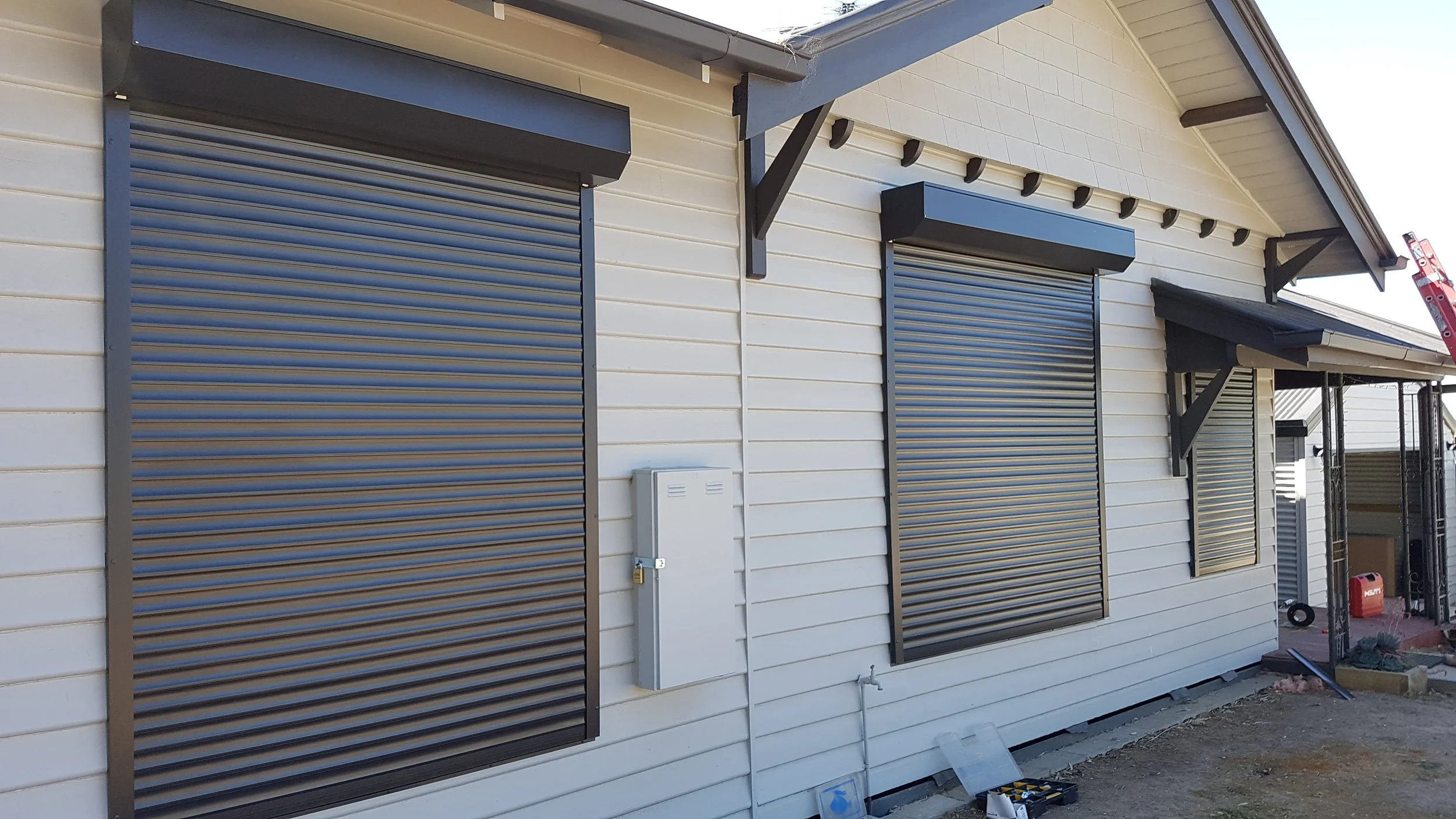 Black roller window shutters on home.jpg
