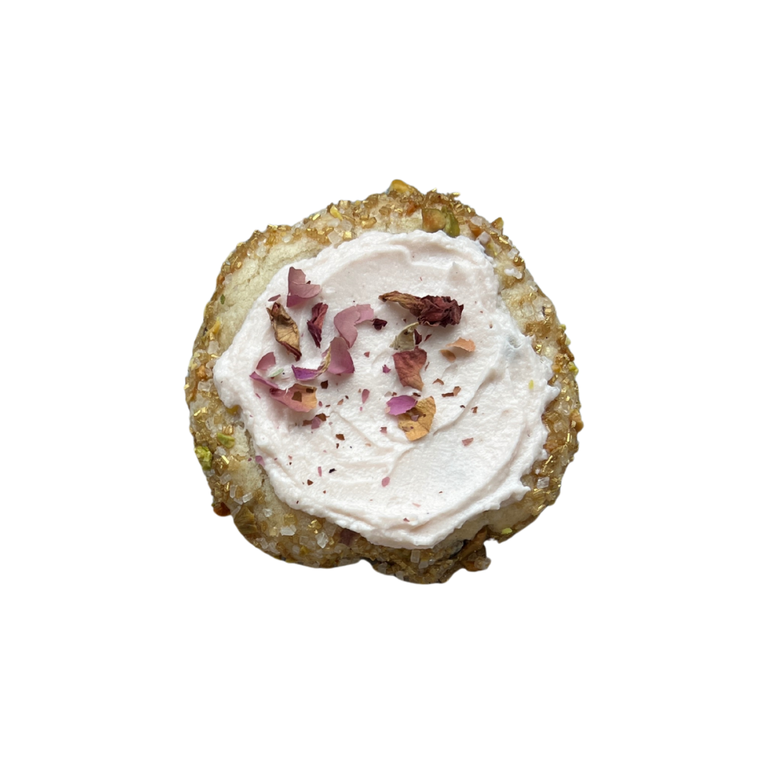 Rose pistachio shortbread cookie with sugar-pistachio crust, rose cream cheese frosting, and dried petals for a delicate, floral finish