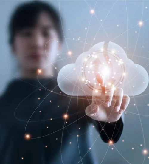 Person pointing at a digital cloud with glowing, interconnected light points and lines.