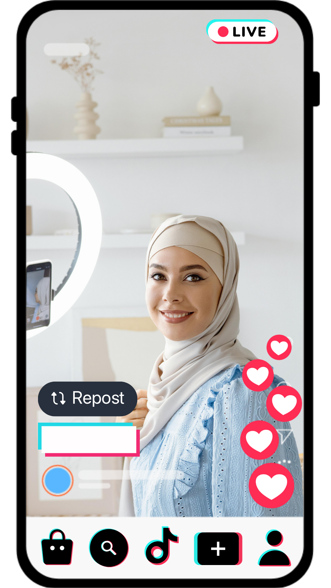 A woman wearing a beige hijab and a blue embroidered top is smiling at her reflection in a ring light while recording a live video on a social media platform in a bright, minimalist room with shelves and decorative items from Live Sell Academy