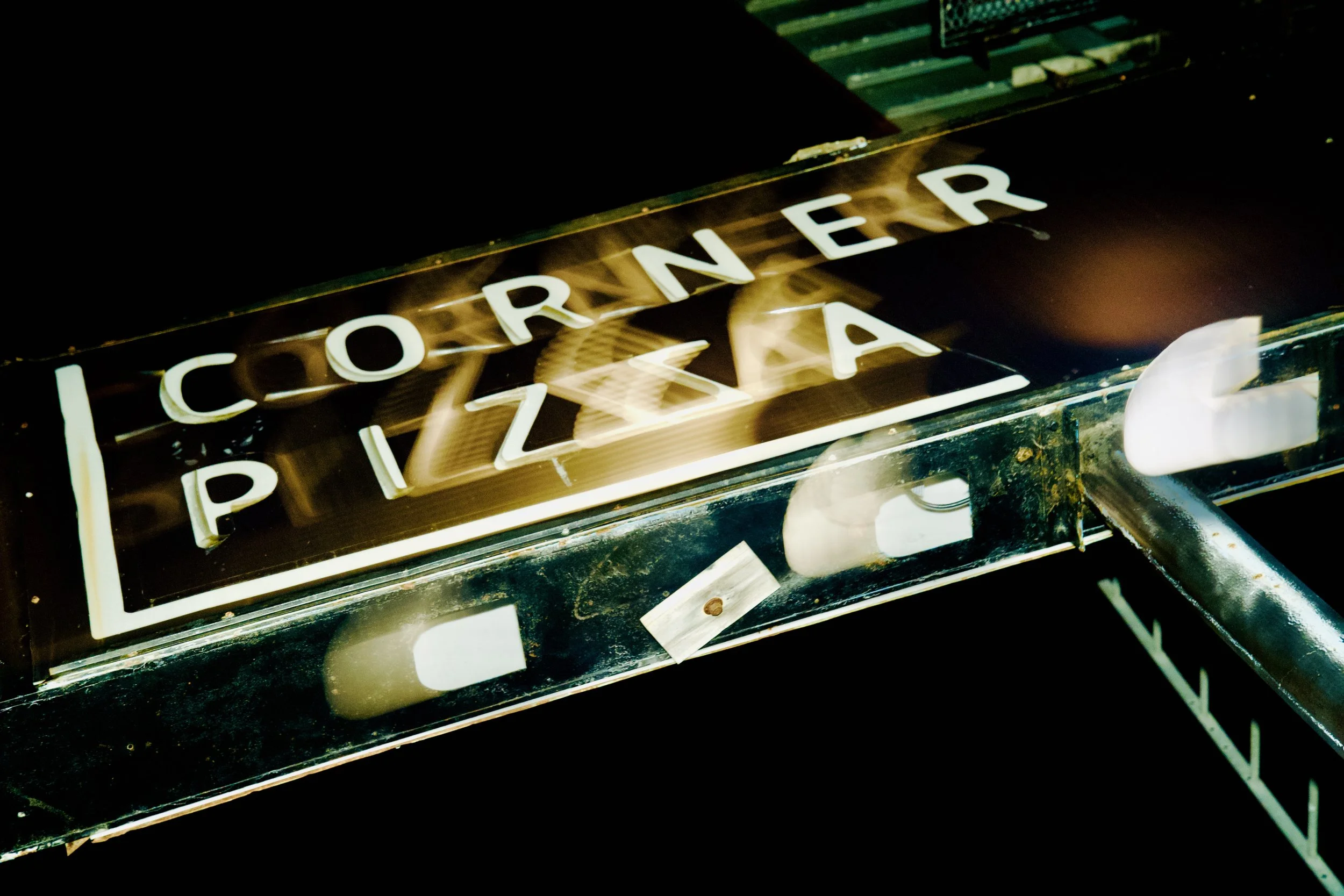 Close-up of an old, vintage jukebox with neon lights and illuminated letters spelling 'ROCKER' on the front.
