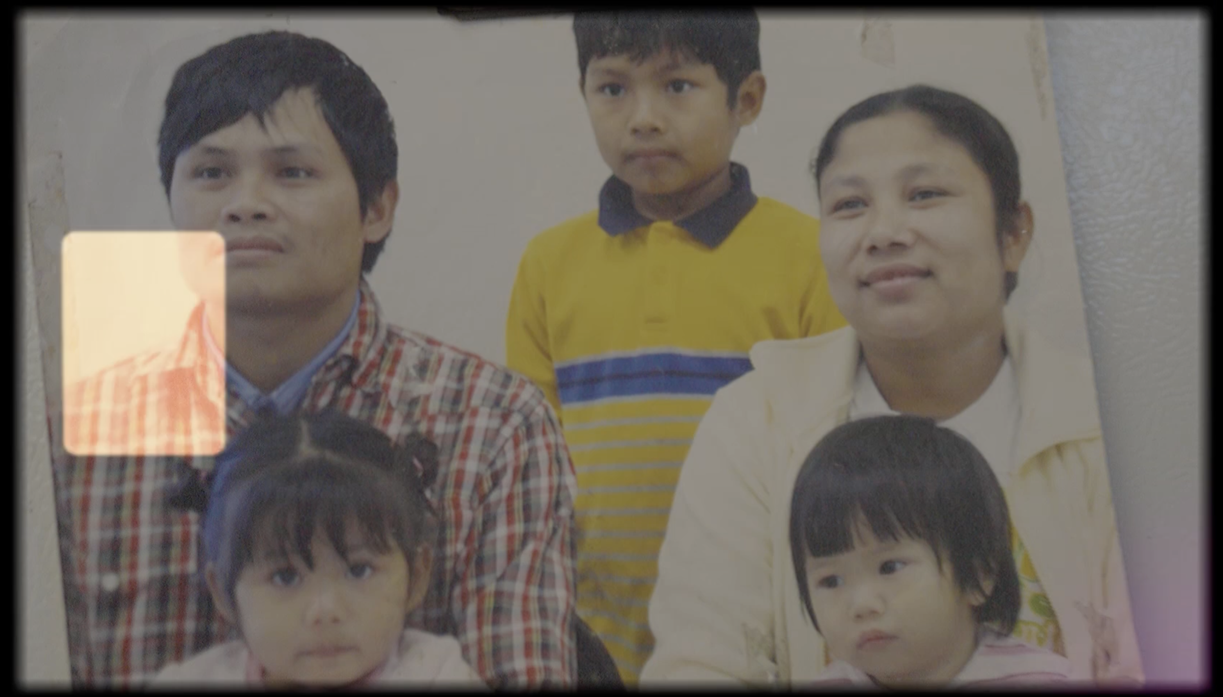 Group photo of three young children and three adults, with some children visible in the foreground.