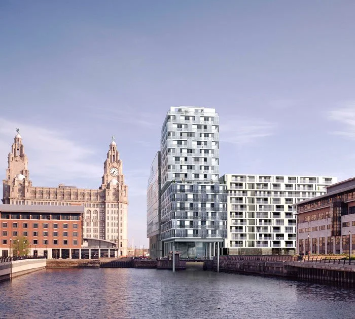 Looking down the riverfront towards the modern high-rise apartment buildings of the proposed New World Square with the historic Royal Liver Building in the far distance opposite, surrounded in an urban setting.