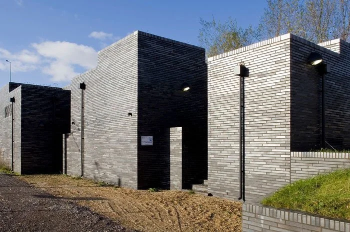 Modern building with black and white brick walls and exterior lights