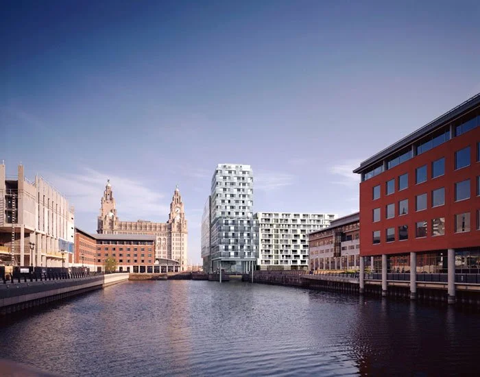 Looking down the riverfront towards the modern high-rise apartment buildings of the proposed New World Square with the historic Royal Liver Building in the far distance opposite, surrounded in an urban setting.