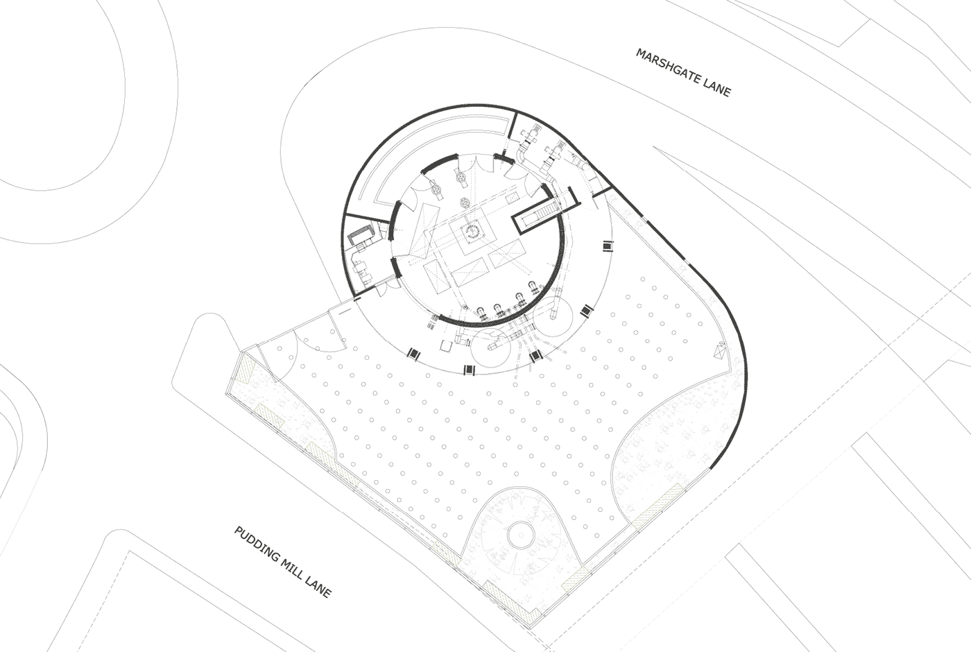Architectural blueprint of the Pudding Mill Pumping Station building with a circular central area, adjacent outdoor space, and street labels for Marshgate Lane and Pudding Mill Lane.