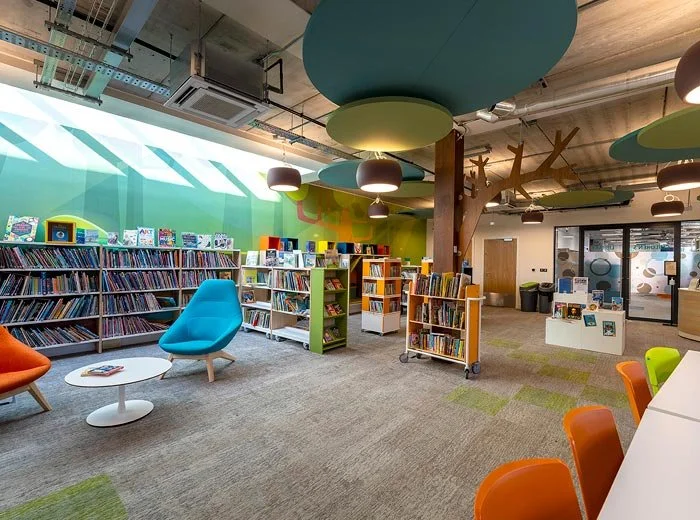 The children's section of the Northcote Library with colourful chairs, bookshelves, and playful ceiling decorations