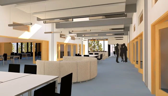 A rendering of the internal reception and lounge for the US Air Force school with tables, chairs, and a curved seating area, illuminated by ceiling lights and natural light from large windows.