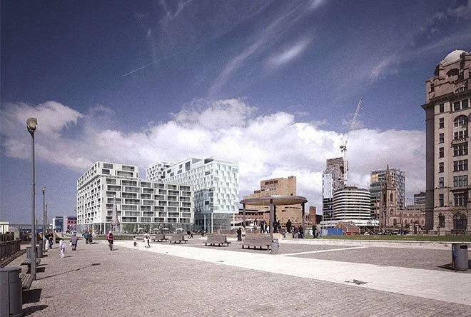 People walking on a promenade of Liverpool with modern building of New World Square in the background against a cloudy sky.