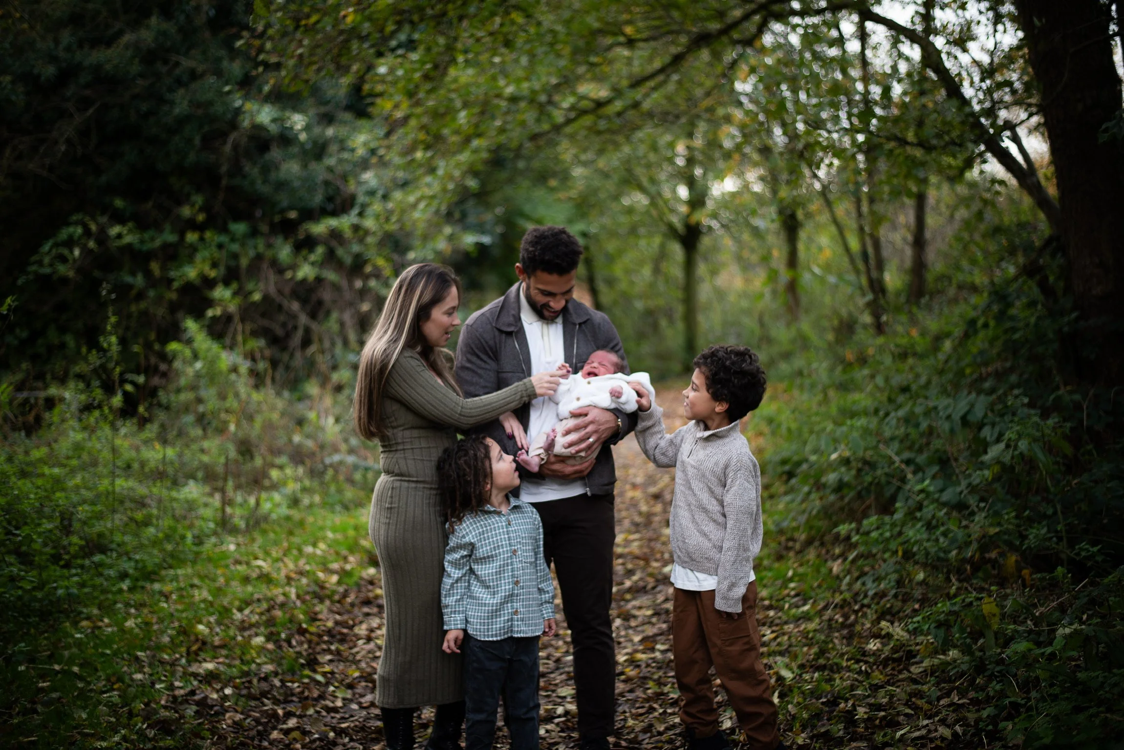 Family surround newborn baby woodland outdoor photography Lichfield