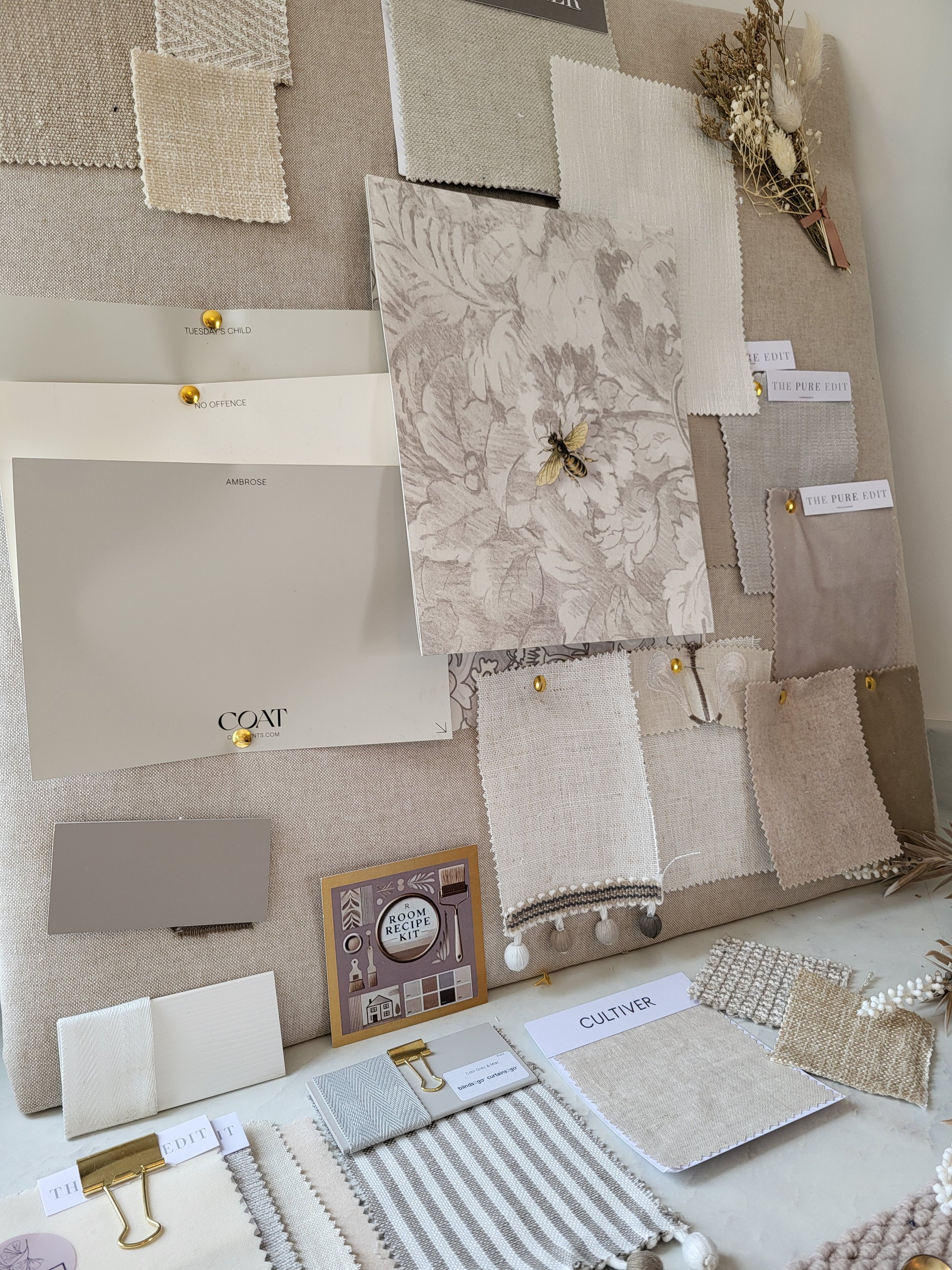 Grey, Taupe's and off white with a beautiful bee colour palette with wallpaper, paint, fabric swatches and samples. Carpet & flooring samples.