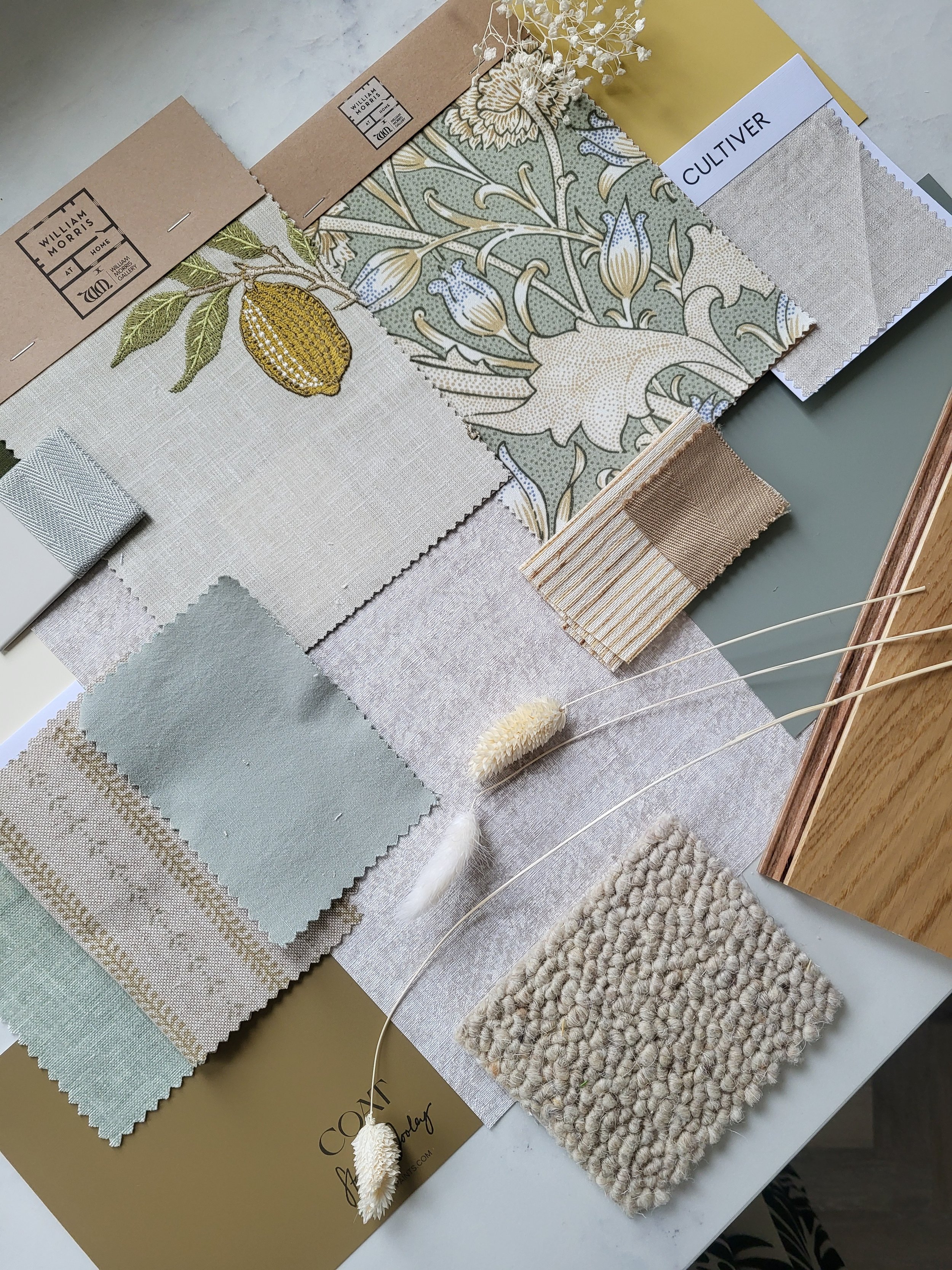 Natural fabrics, greens & a hint of yellow colour palette with wallpaper, paint, fabric swatches and samples. Carpet & flooring samples.
