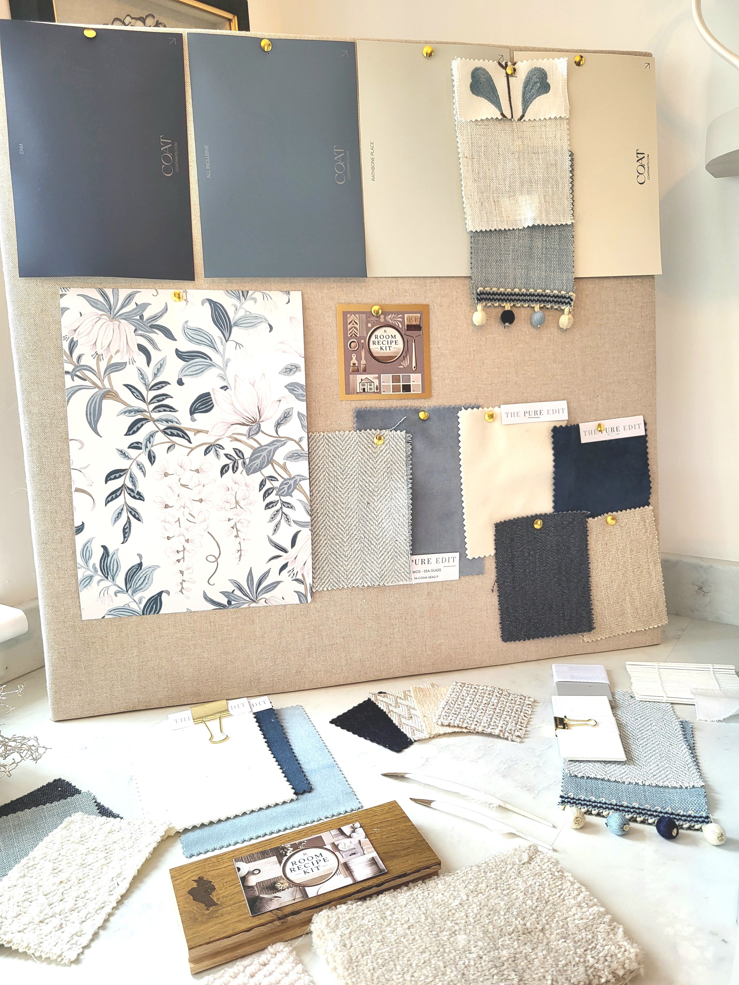 Blues and soft whites colour palette with wallpaper, paint, fabric swatches and samples. Carpet & flooring samples.