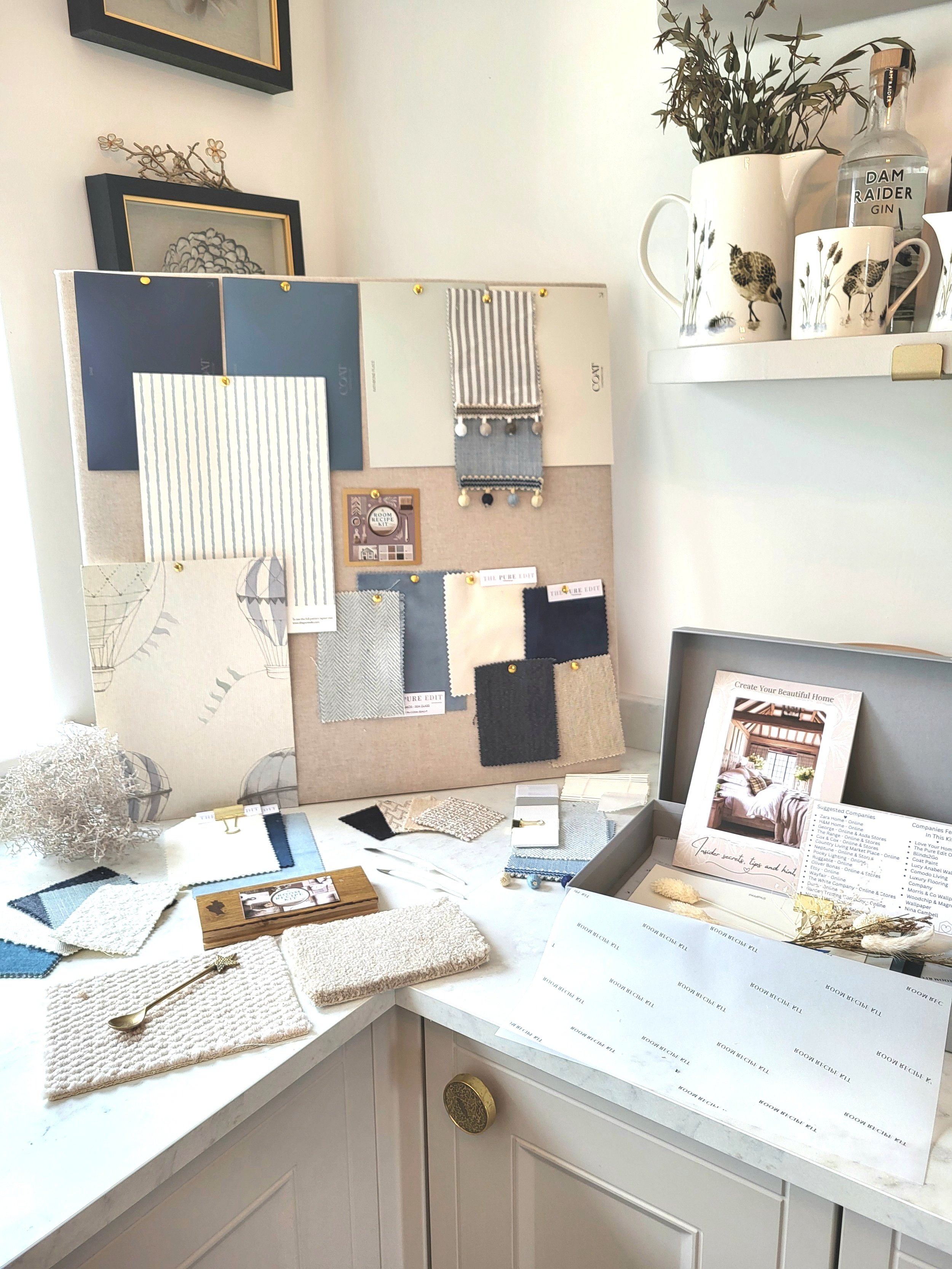 Blues & off white colour palette for babys nursery with wallpaper, paint, fabric swatches and samples. Carpet & flooring samples.