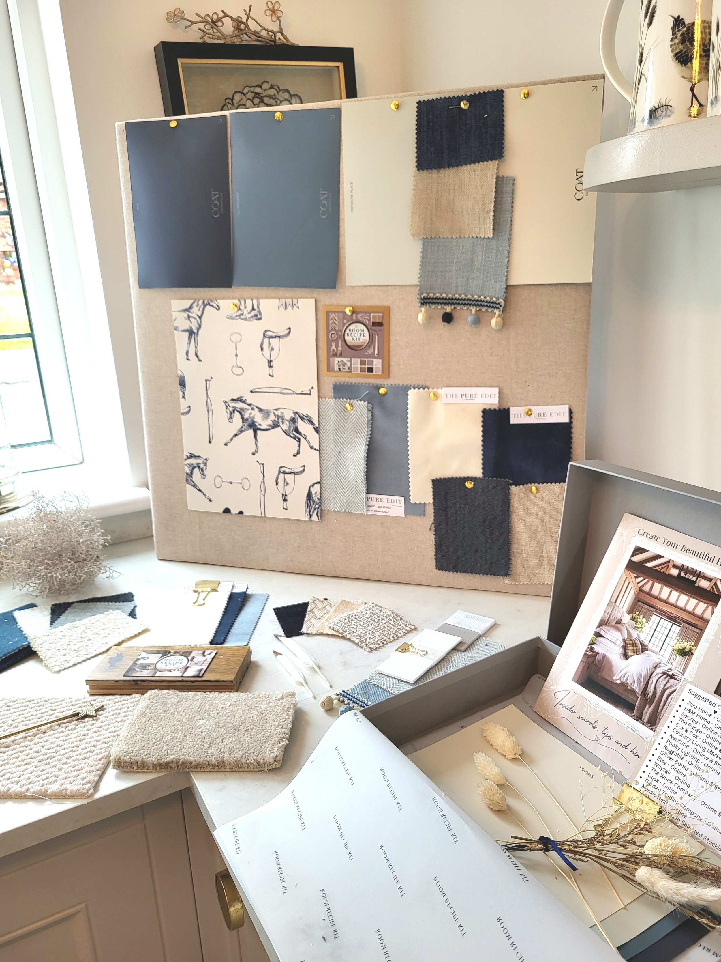Blues and soft whites colour palette with wallpaper, paint, fabric swatches and samples. Carpet & flooring samples.