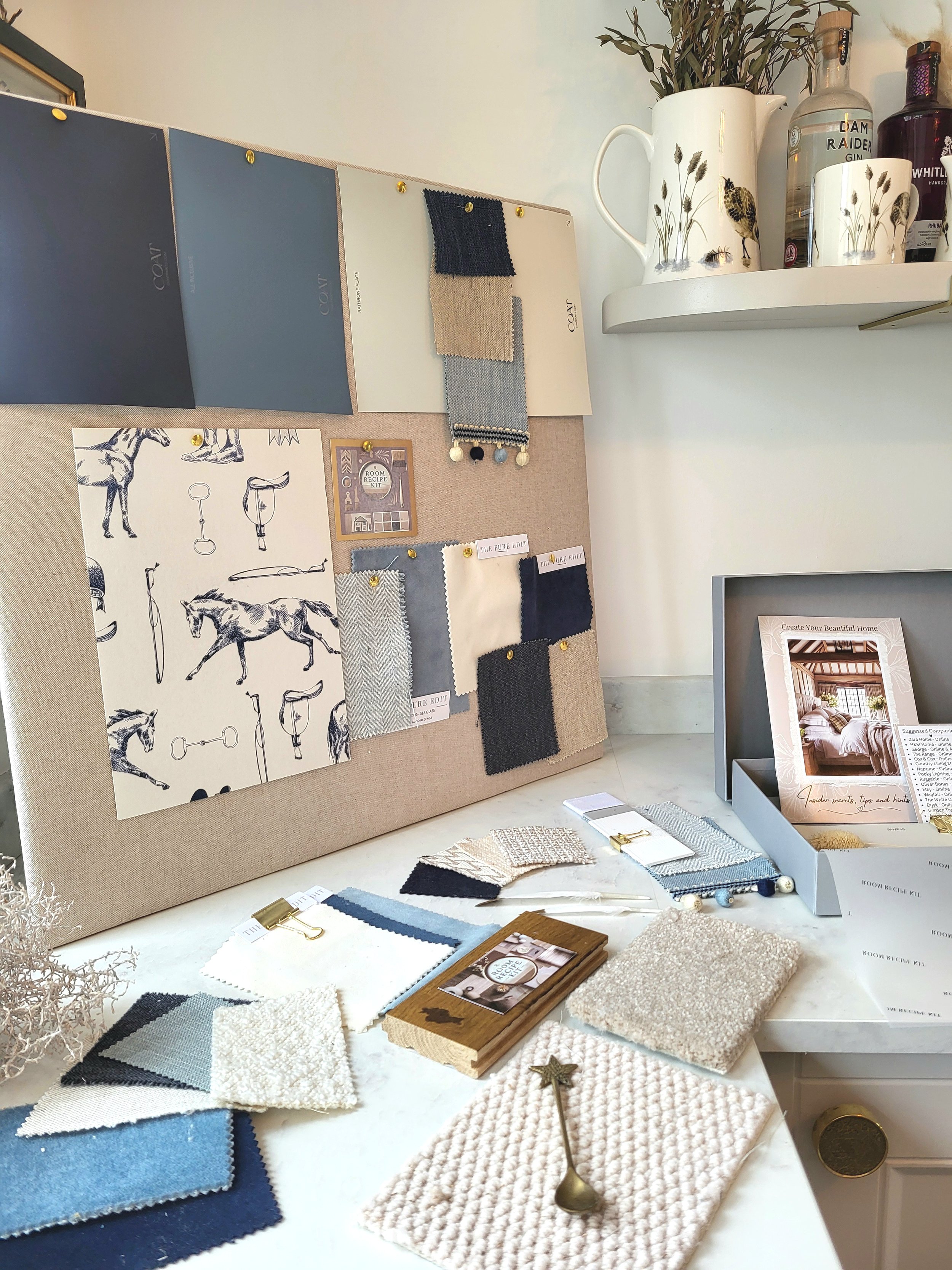 Blues and soft whites colour palette with wallpaper, paint, fabric swatches and samples. Carpet & flooring samples.