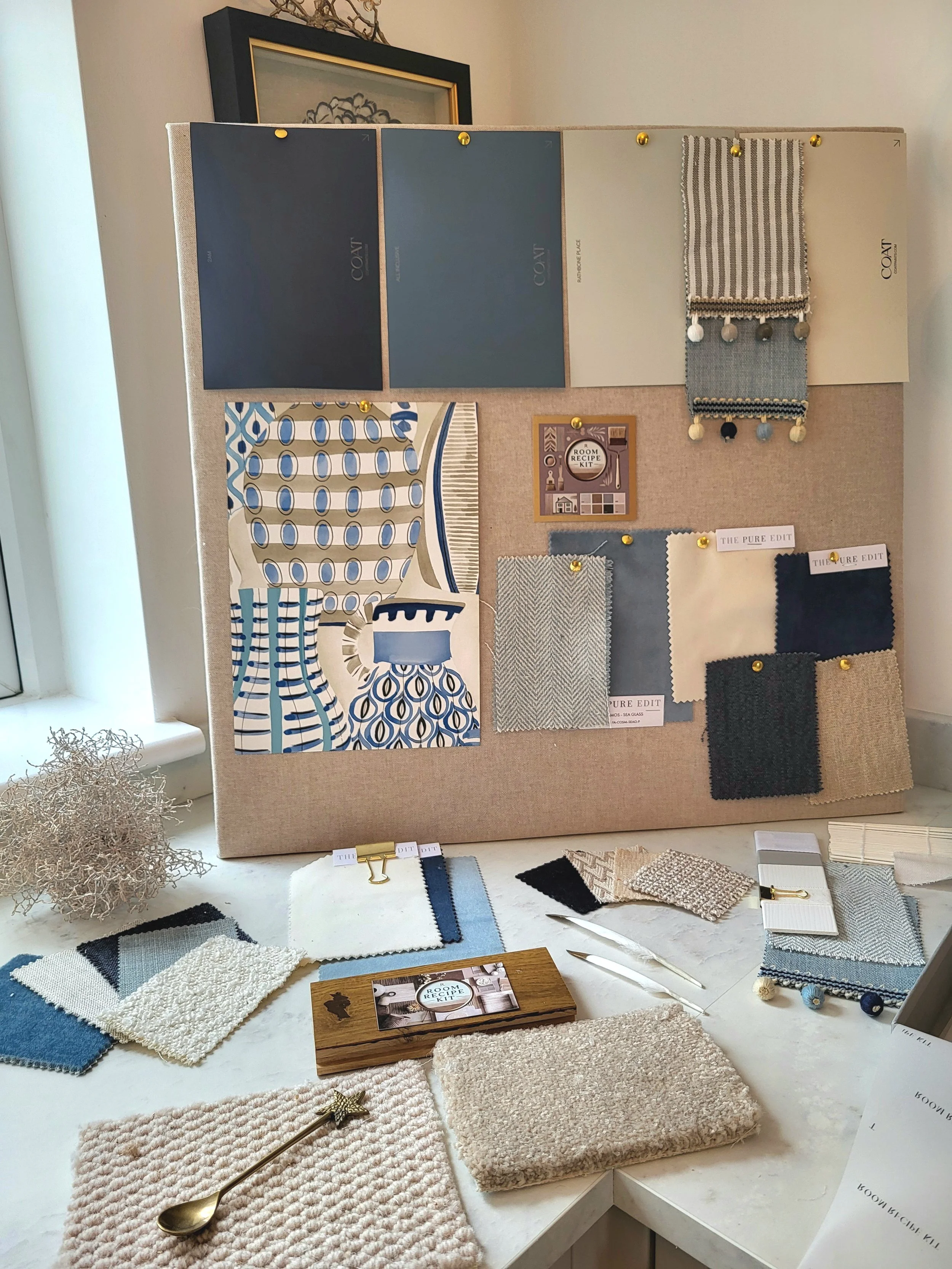 Blues and soft whites colour palette with wallpaper, paint, fabric swatches and samples. Carpet & flooring samples.