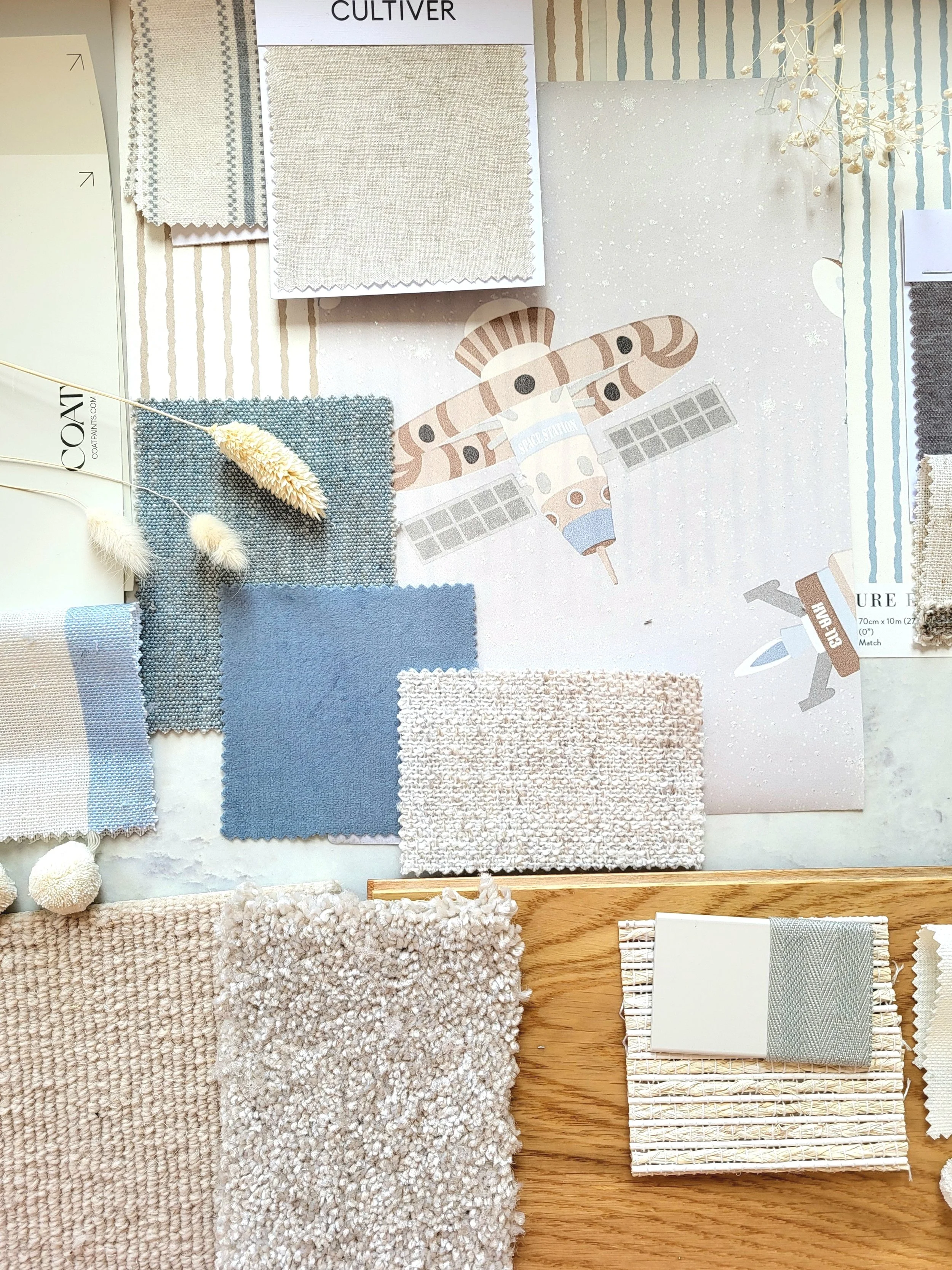 Nude,Blue & Bluey Greens colour palette for baby's nursery or children's bedroom with wallpaper, paint, fabric swatches and samples. Carpet & flooring samples.