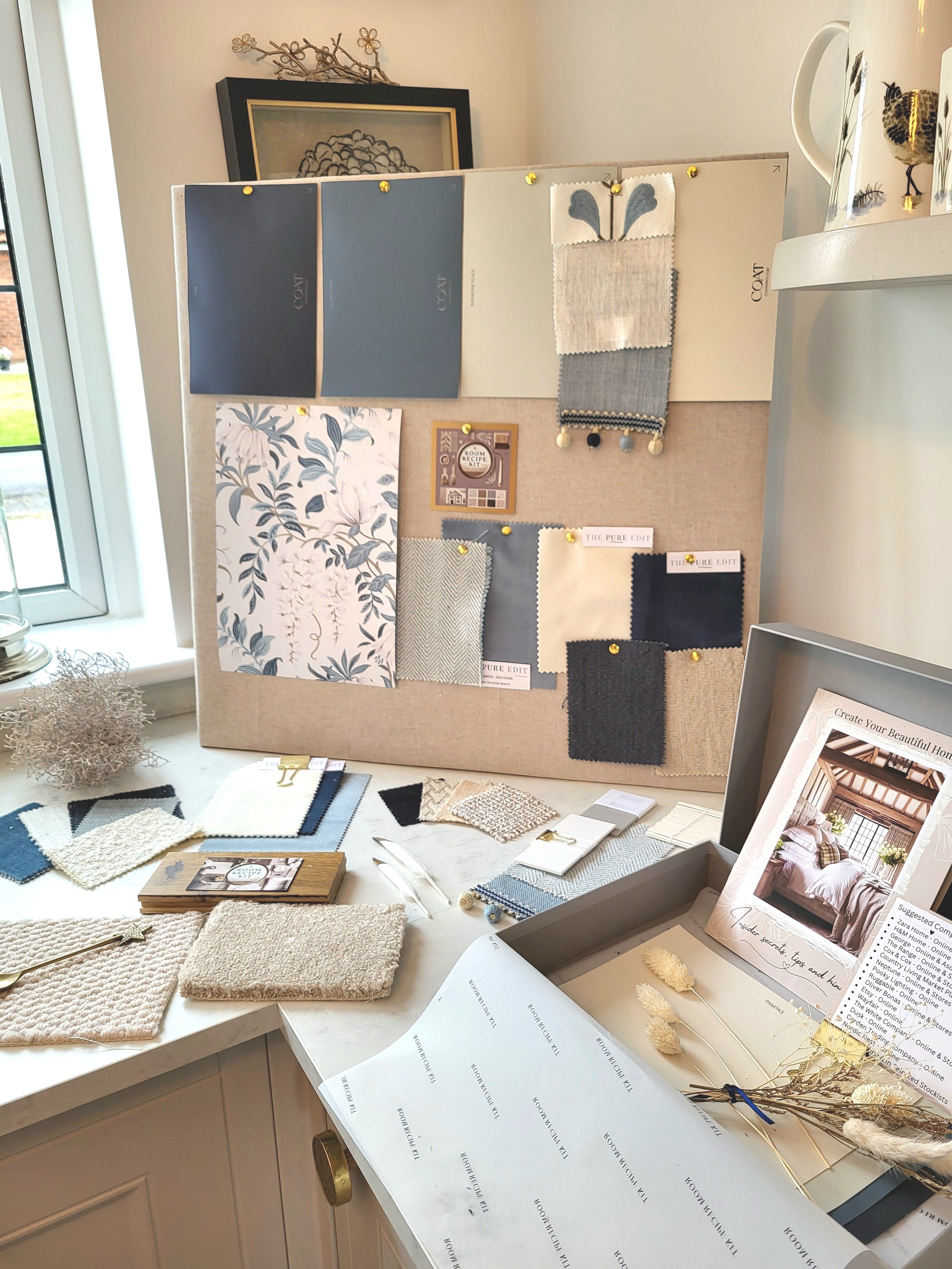 Blues and soft whites colour palette with wallpaper, paint, fabric swatches and samples. Carpet & flooring samples.