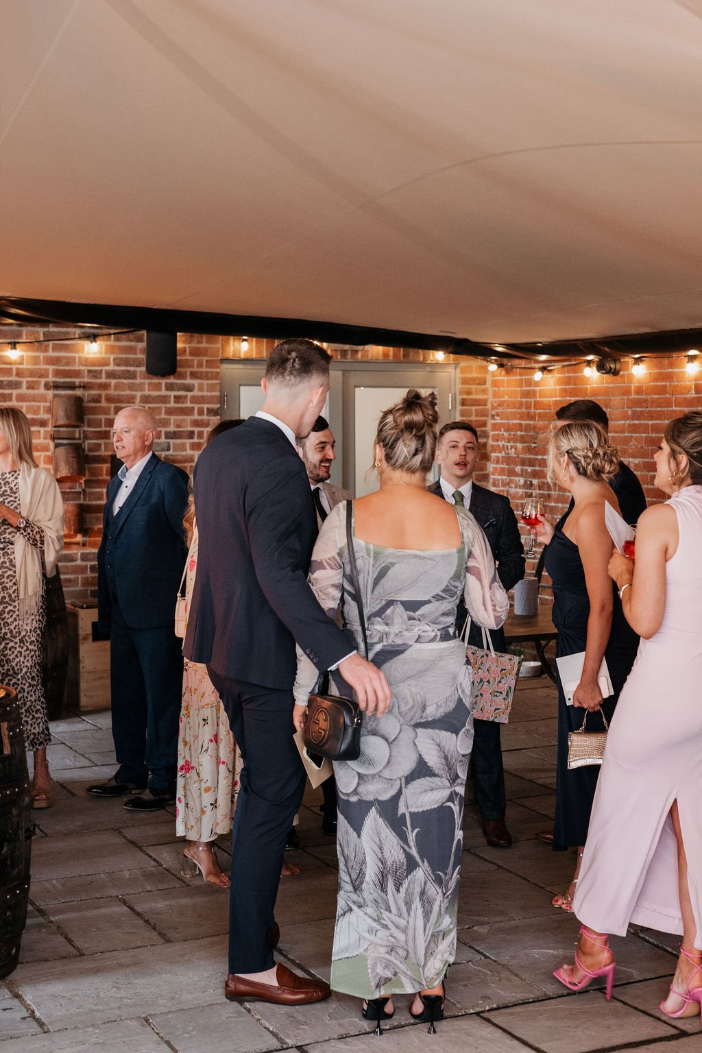 People in formal attire at a social gathering indoors