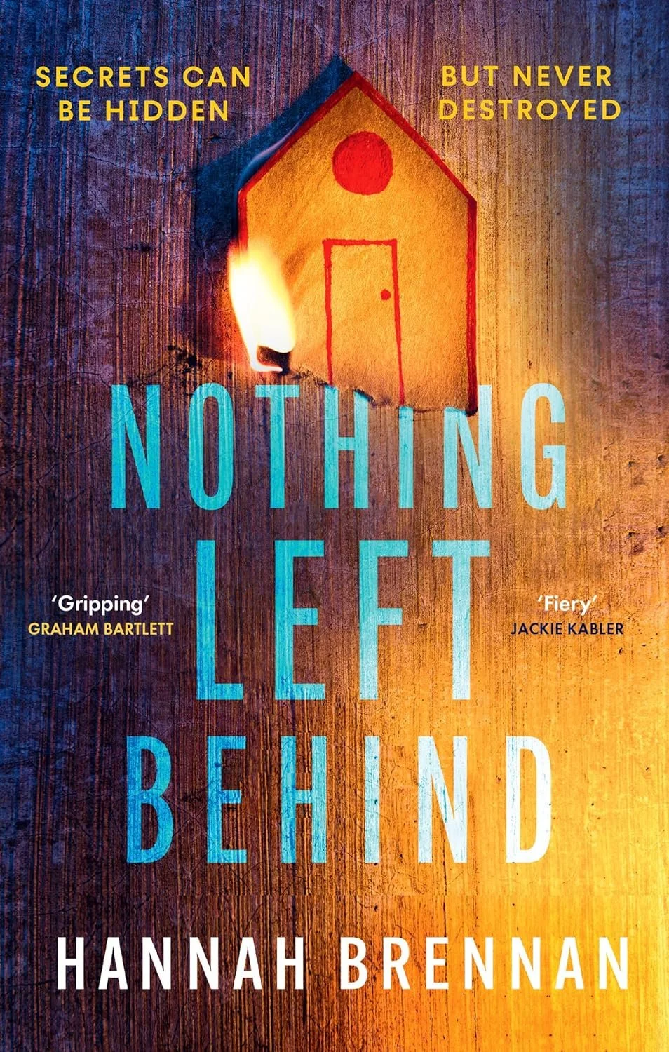Book cover of 'Nothing Left Behind' by Hannah Brennan, featuring a matchstick igniting a paper house illustration with a wooden background