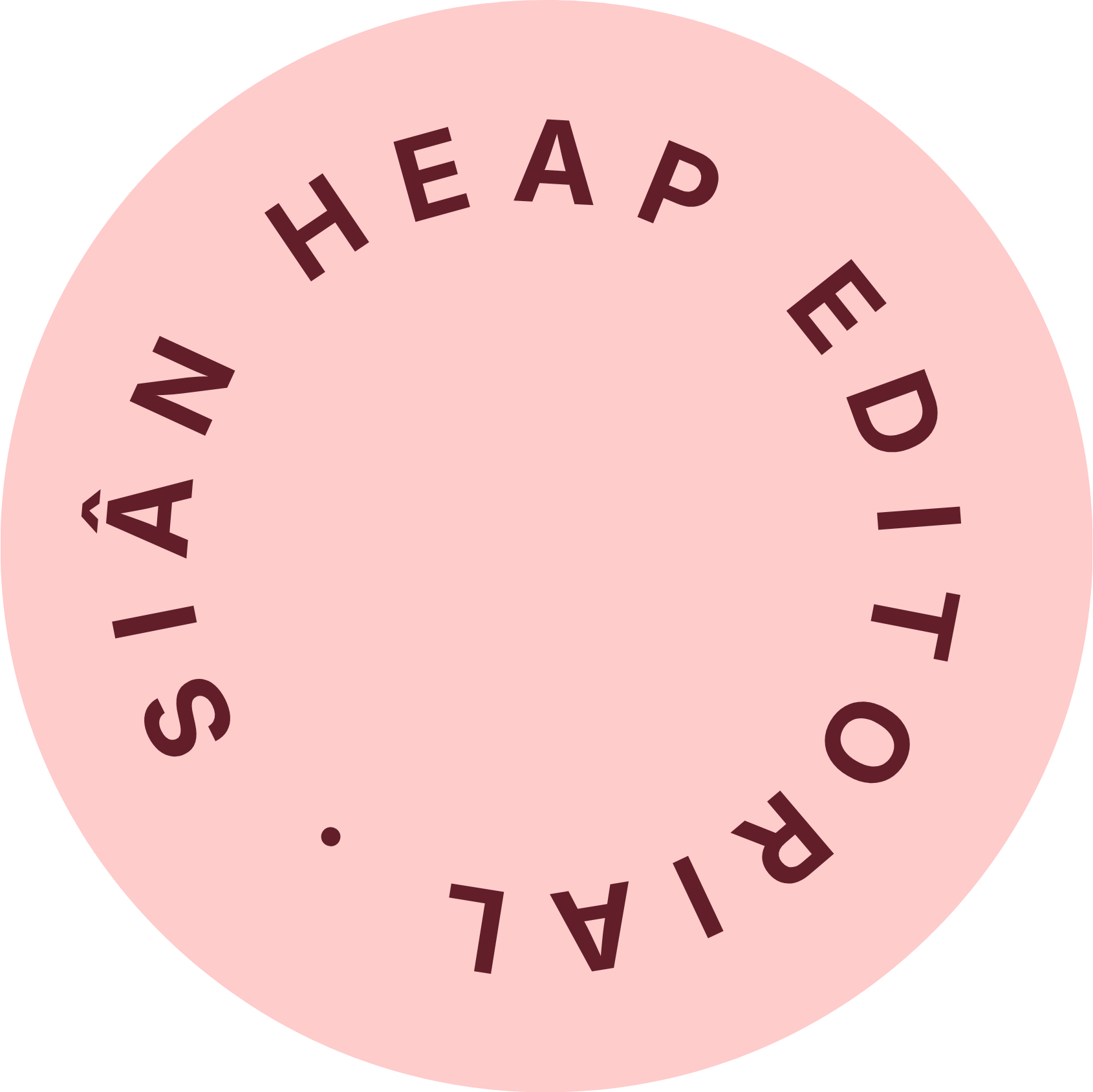 Close-up of a circular pink object with the words "RAILWAYSTATION" written in a circle around the edge.