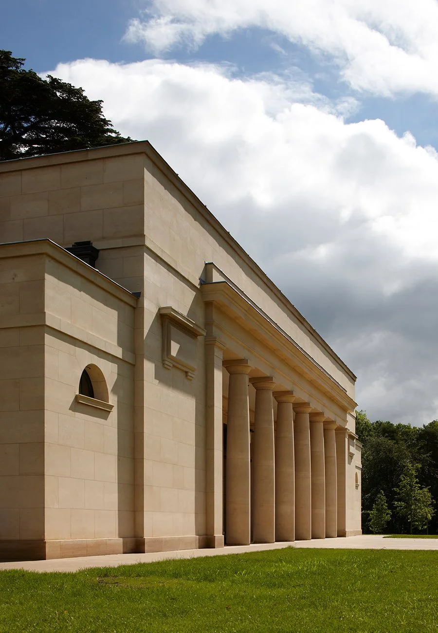Side elevation of a classical limestone bath house in Gloucestershire featuring a monumental colonnade and formal architectural detailing.