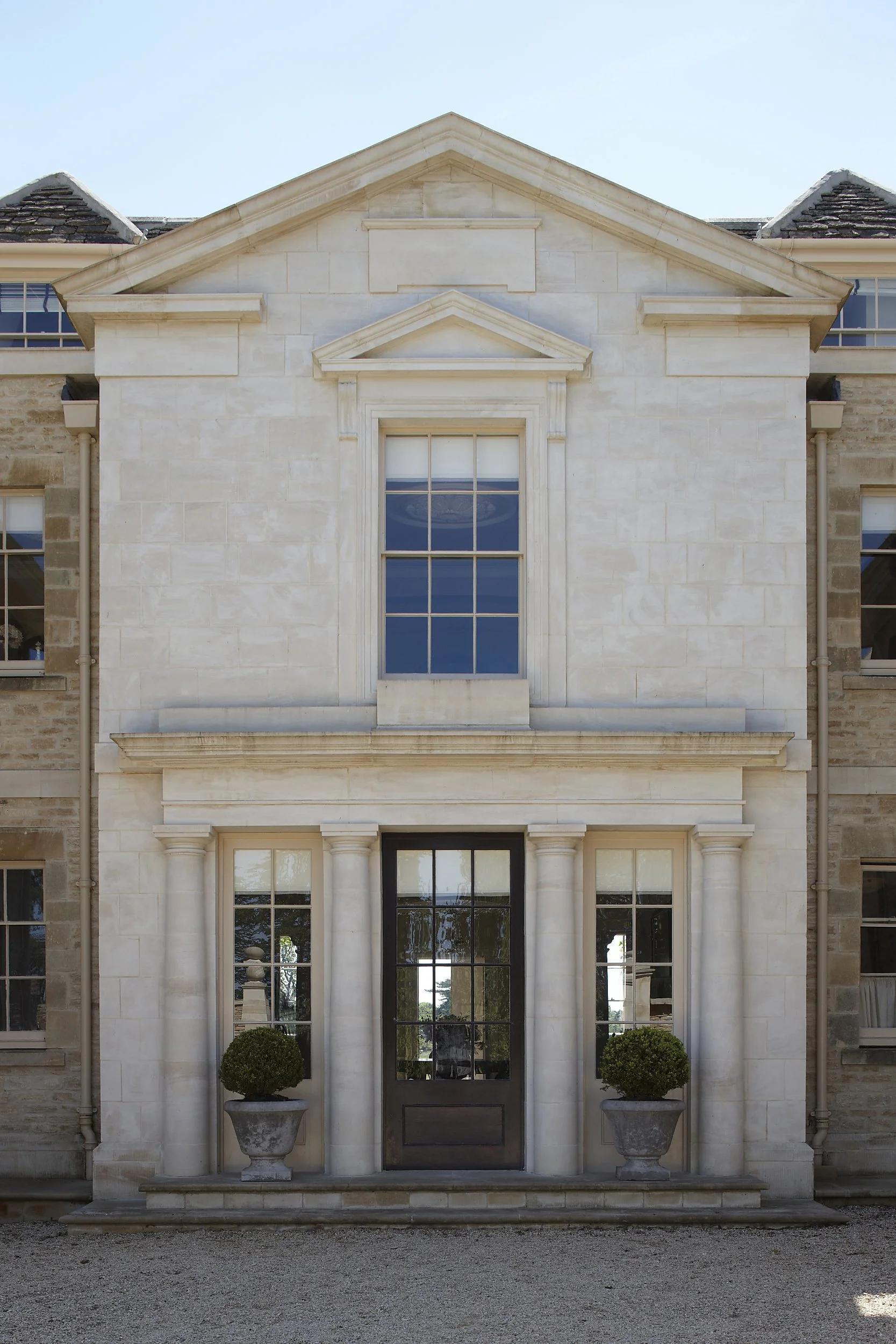 Classical limestone entrance façade with portico, columns and pediment detailing by Craig Hamilton Architects