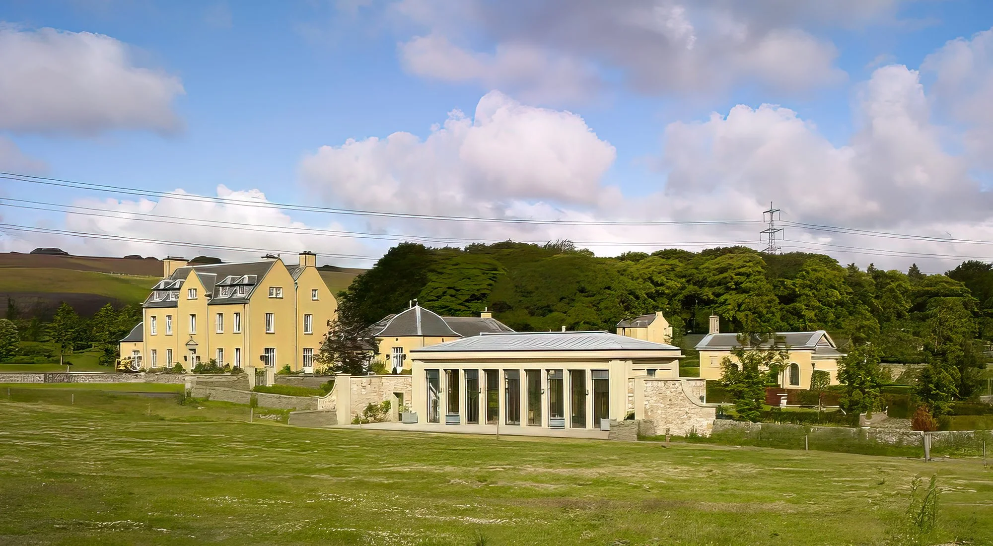 Orangery viewed within its wider estate setting, showing the relationship between the garden building, surrounding landscape and principal house.