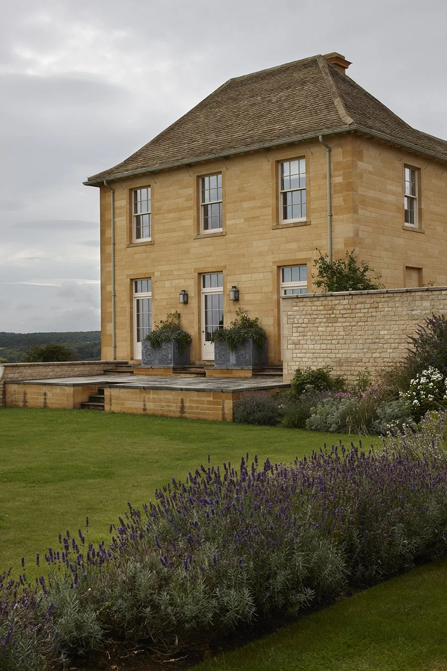 Classical stone country house and landscaped garden by Craig Hamilton Architects