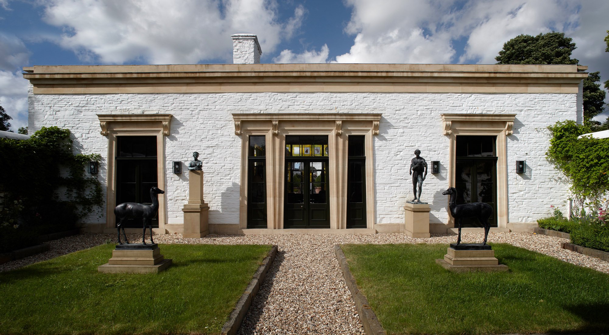 Symmetrical classical courtyard façade in the Welsh hills by Craig Hamilton Architects