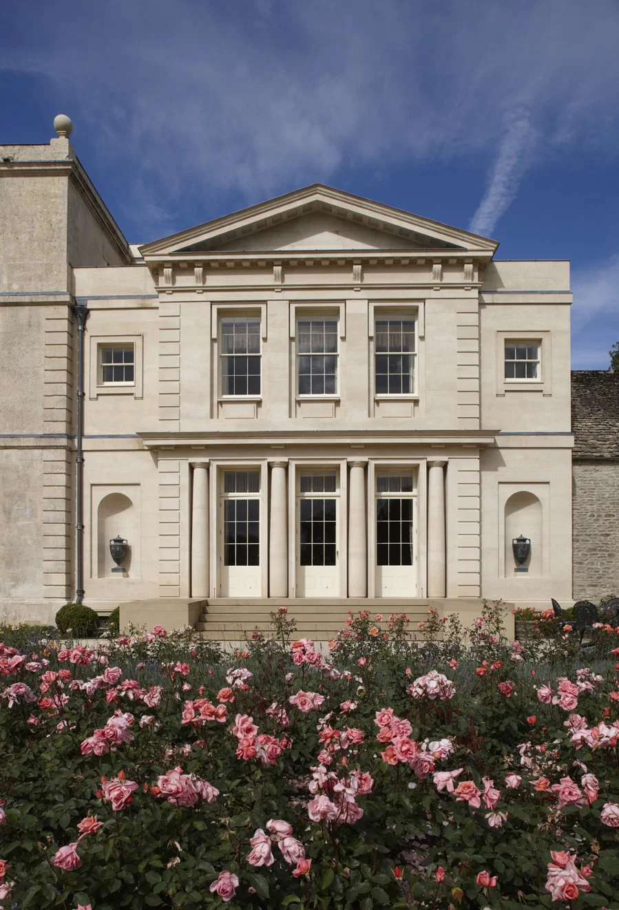 Classical country house façade with rose garden in Gloucestershire by Craig Hamilton Architects