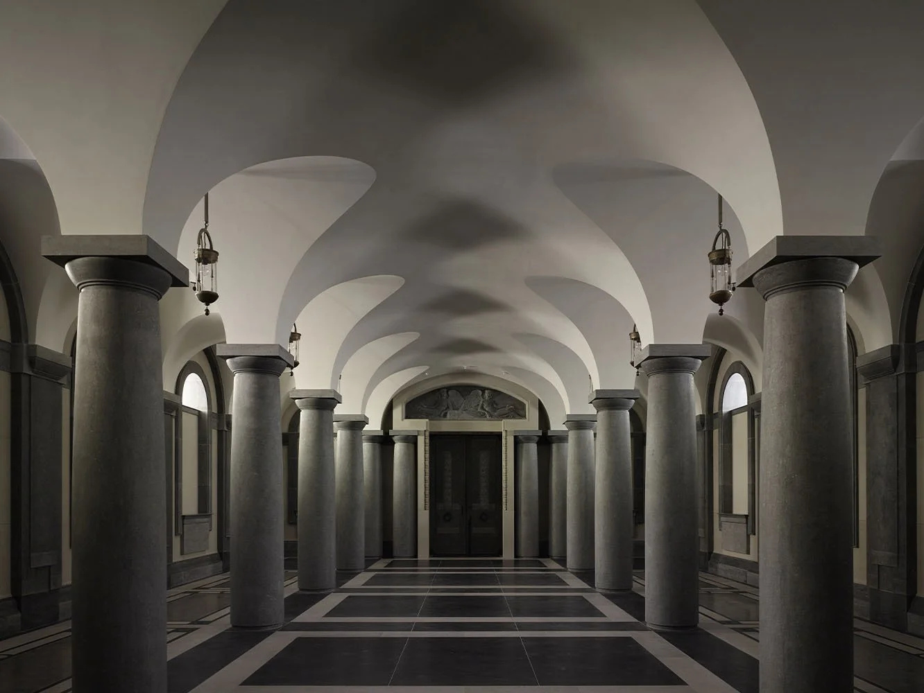 Vaulted crypt corridor with classical stone columns at The Chapel of Christ the Redeemer, Culham.